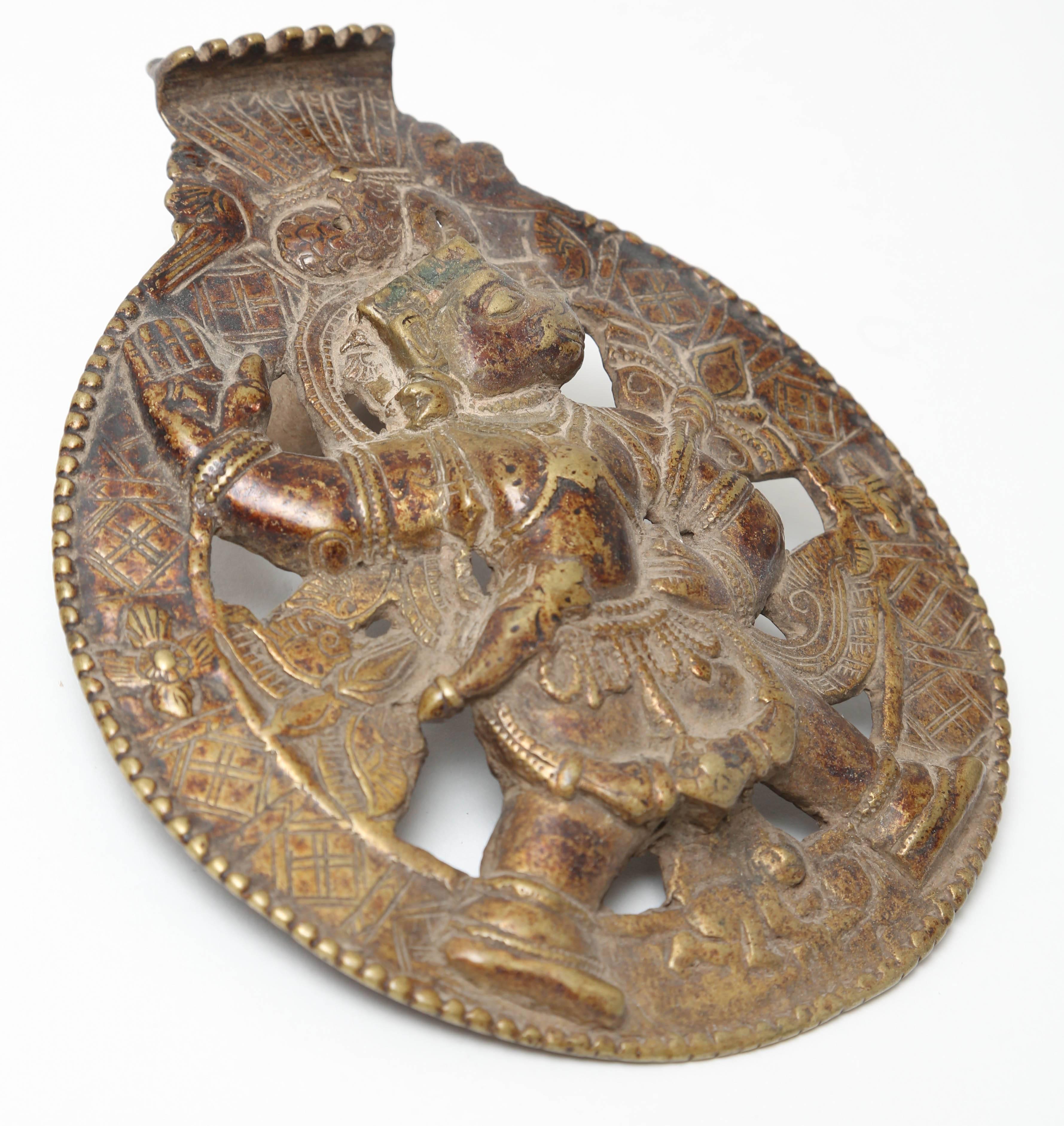 Roundel bronze relief of the god Hanuman shown in profile walking with his right hand raised, 18th-19th century.