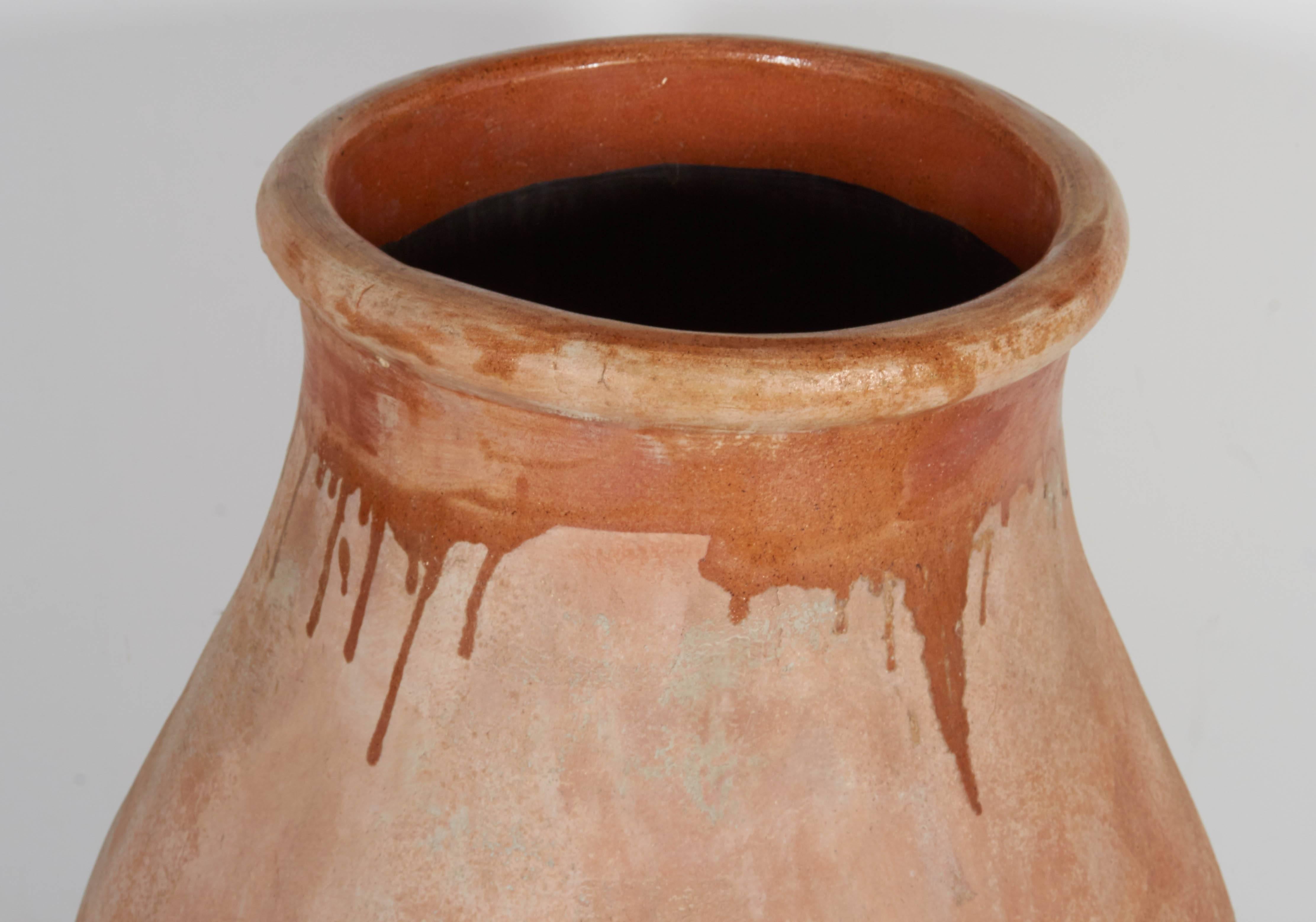 A tall, sensuous jar with faded peachy tones reminiscent of a Greek island. This remarkably graceful piece includes a small drainage hole on the bottom.
CR10015.