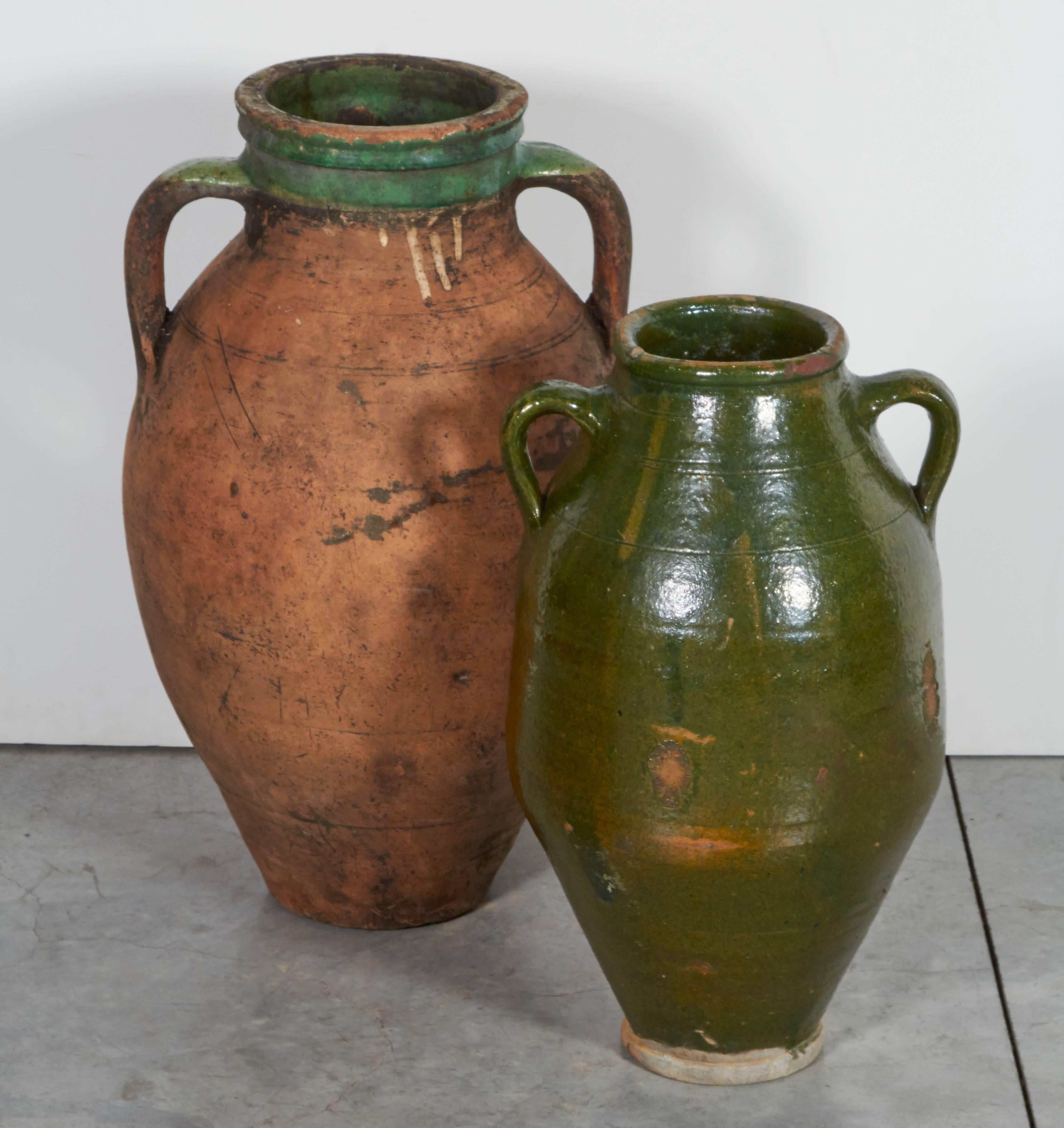 A two handled Mediterranean antique terra cotta olive jar with great wear and classic shape. The matte finish of the body contrasts perfectly with the glazed rim.
CR760.