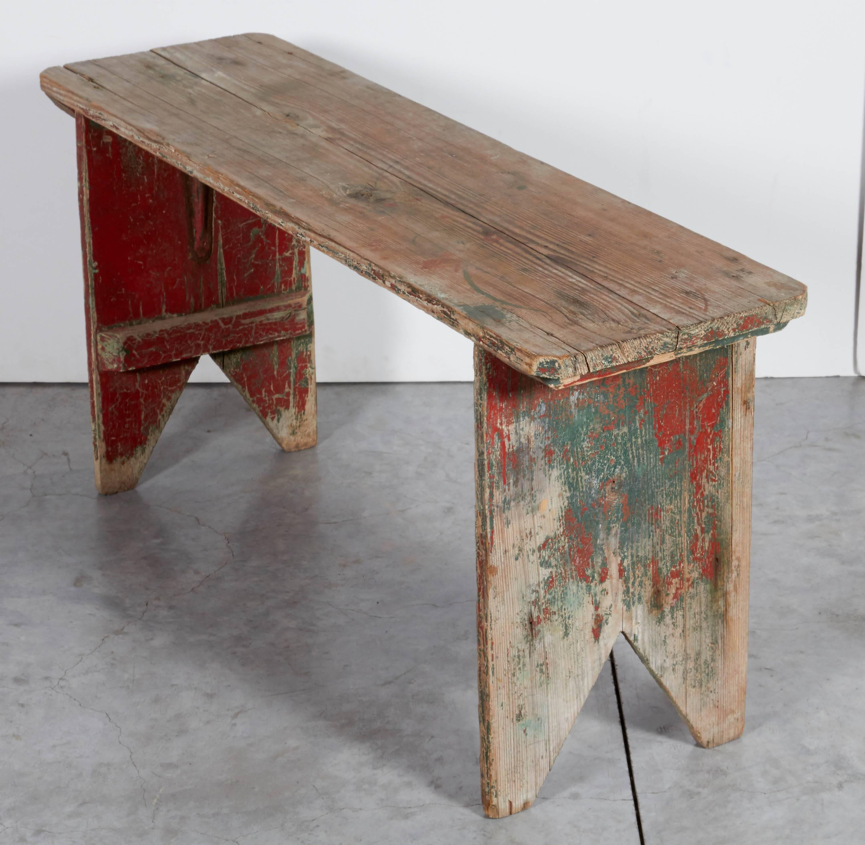 This simple, primitive bench displays years of wear and faded old red and green paint on the legs. This makes a great, colorful accent piece in an entryway or low table for displaying objects or magazines.
BN104.

a b h a y a  in TriBeCa 