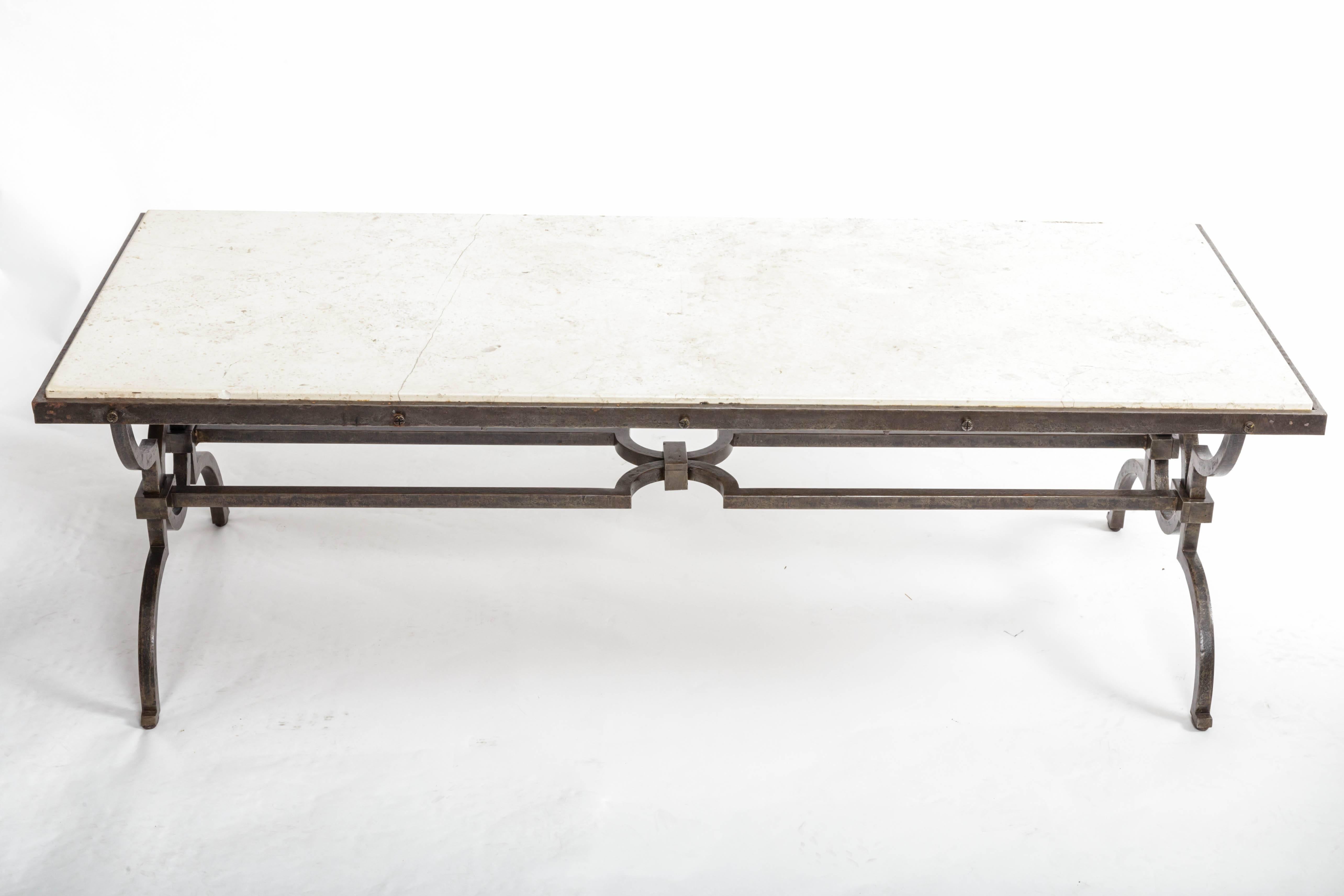 Black patinated and gilded wrought-iron coffee table by Gilbert Poillerat, France, c. 1940s. 

This rare and highly sophisticated coffee table by Gilbert Poillerat consists of a black patinated wrought-iron base, sleek stone top, and elegant gilt