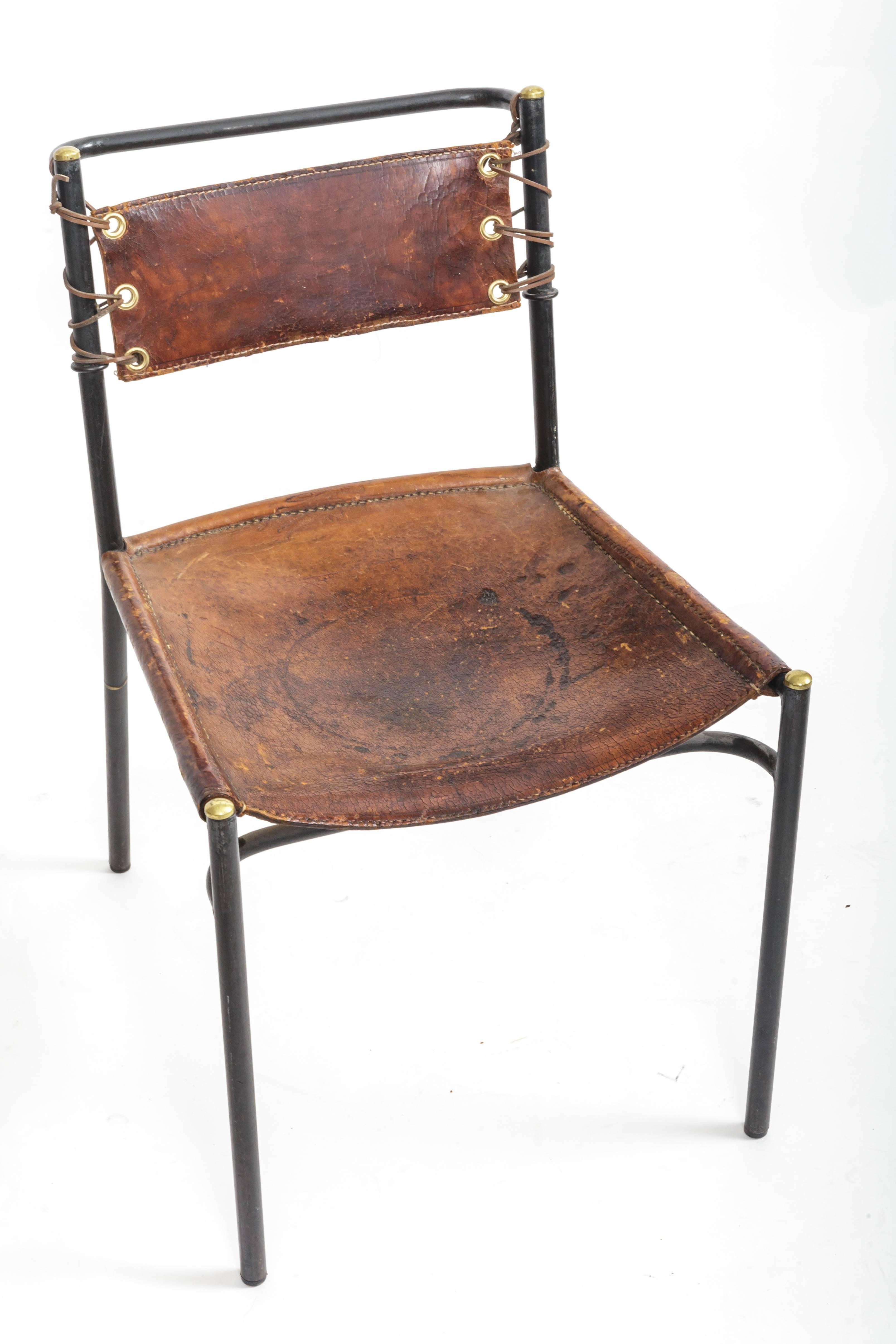 Leather and Metal Chair in the style of Jacques Adnet, France, c. 1950s. 

Simple yet sophisticated design consists of a clean tubular metal frame, leather seat, and hand-tied leather backrest. 

 