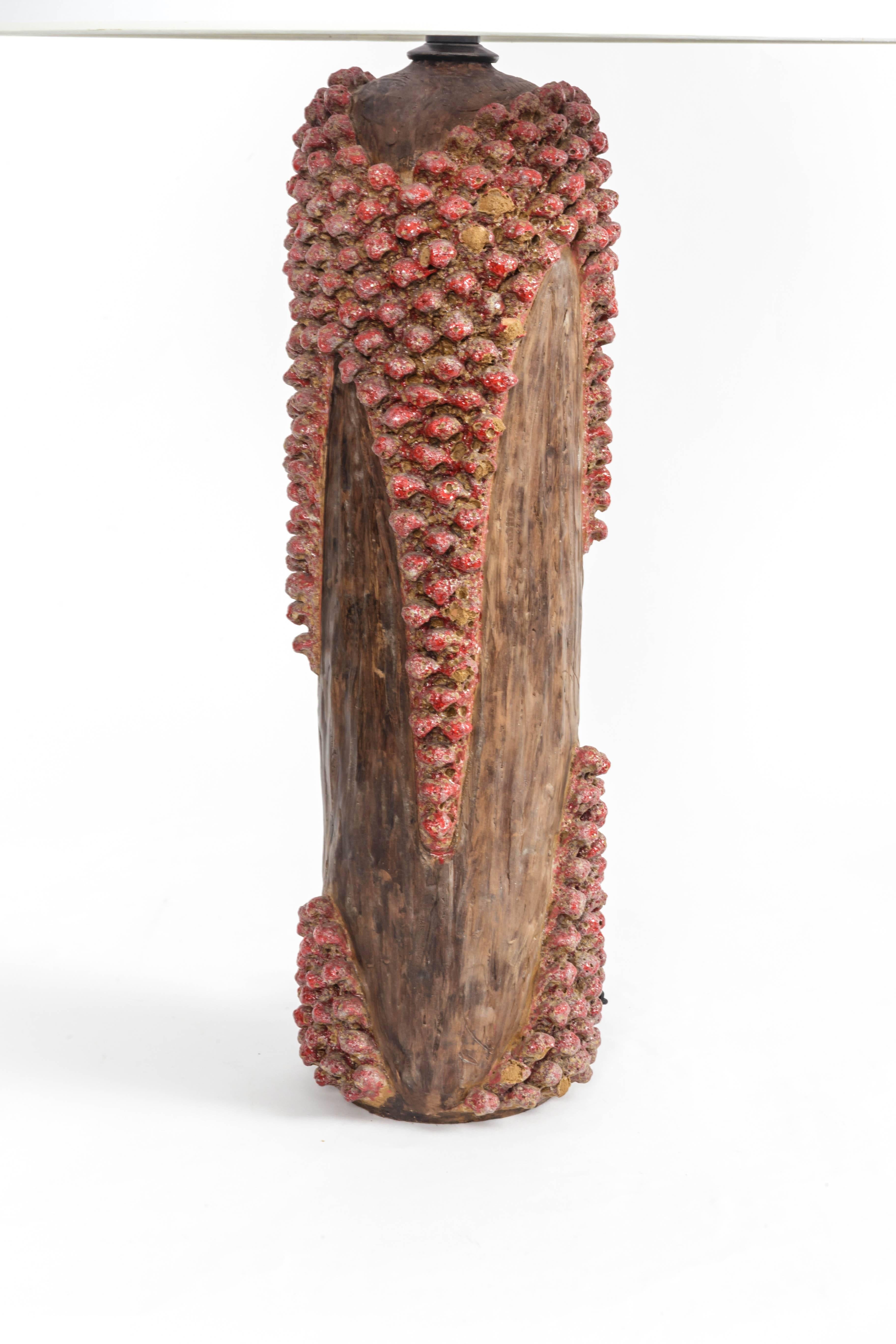 Textured red and brown ceramic lamp, France, 20th century.


Shade not included
Newly rewired with black twisted silk cord and bronze finish on fittings.