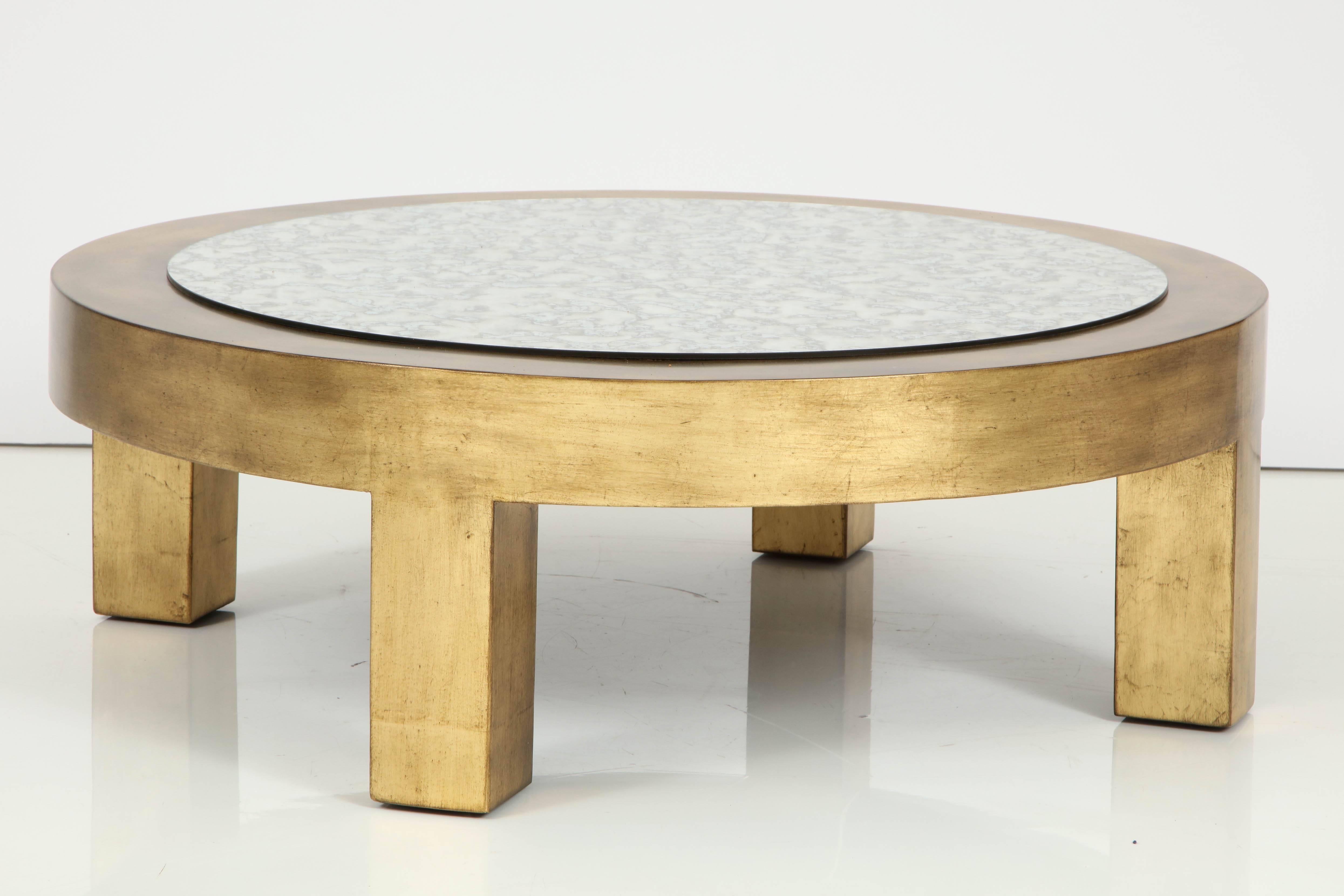 James Mont hand gilded circular coffee table with a smoked eglomise mirror top. The perfect finishing statement for any traditional, glam or modern room. Mint restored.