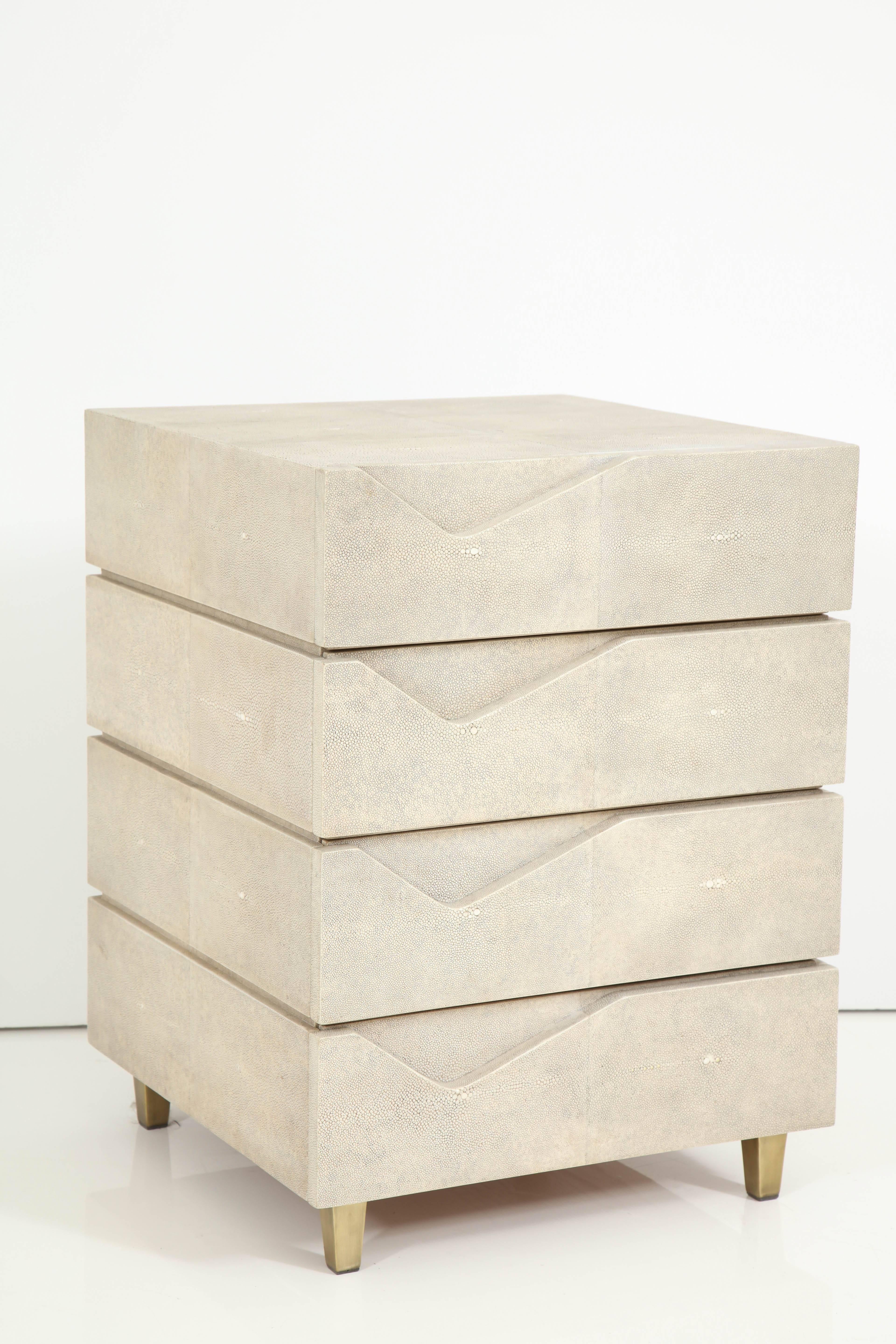Decorative four-drawer side table made of cream color shagreen and bronze legs. We have two of these side tables in stock.