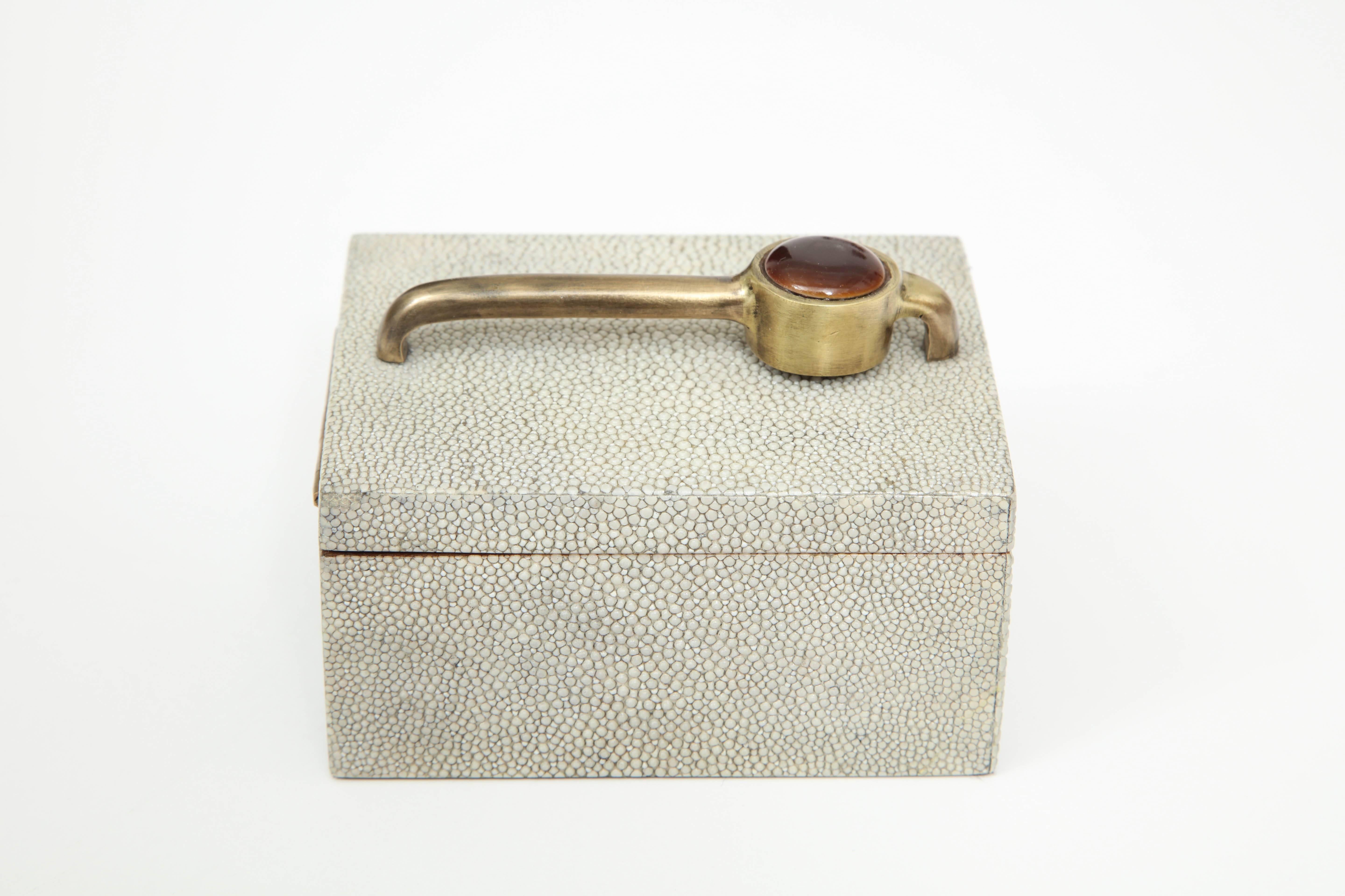 Decorative shagreen box with bronze handle. The inside of the box has a bronze lining.