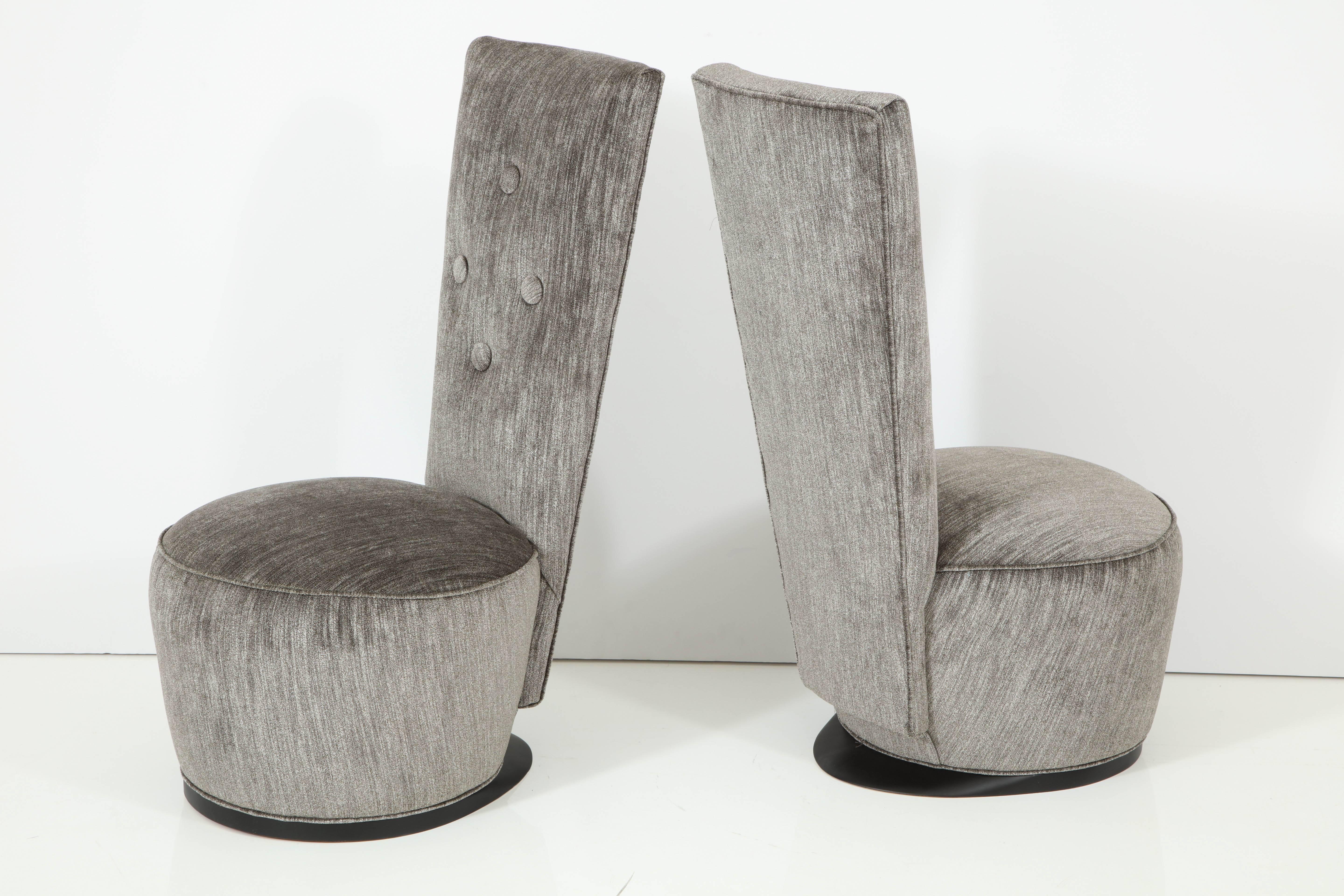 Elegant pair of Dolphin slipper chairs designed by James Mont.
The chairs have been newly reupholstered in a luxurious silvery grey velvet and they
sit on satin black wooden bases that have been newly refinished.
The back height of the chair is