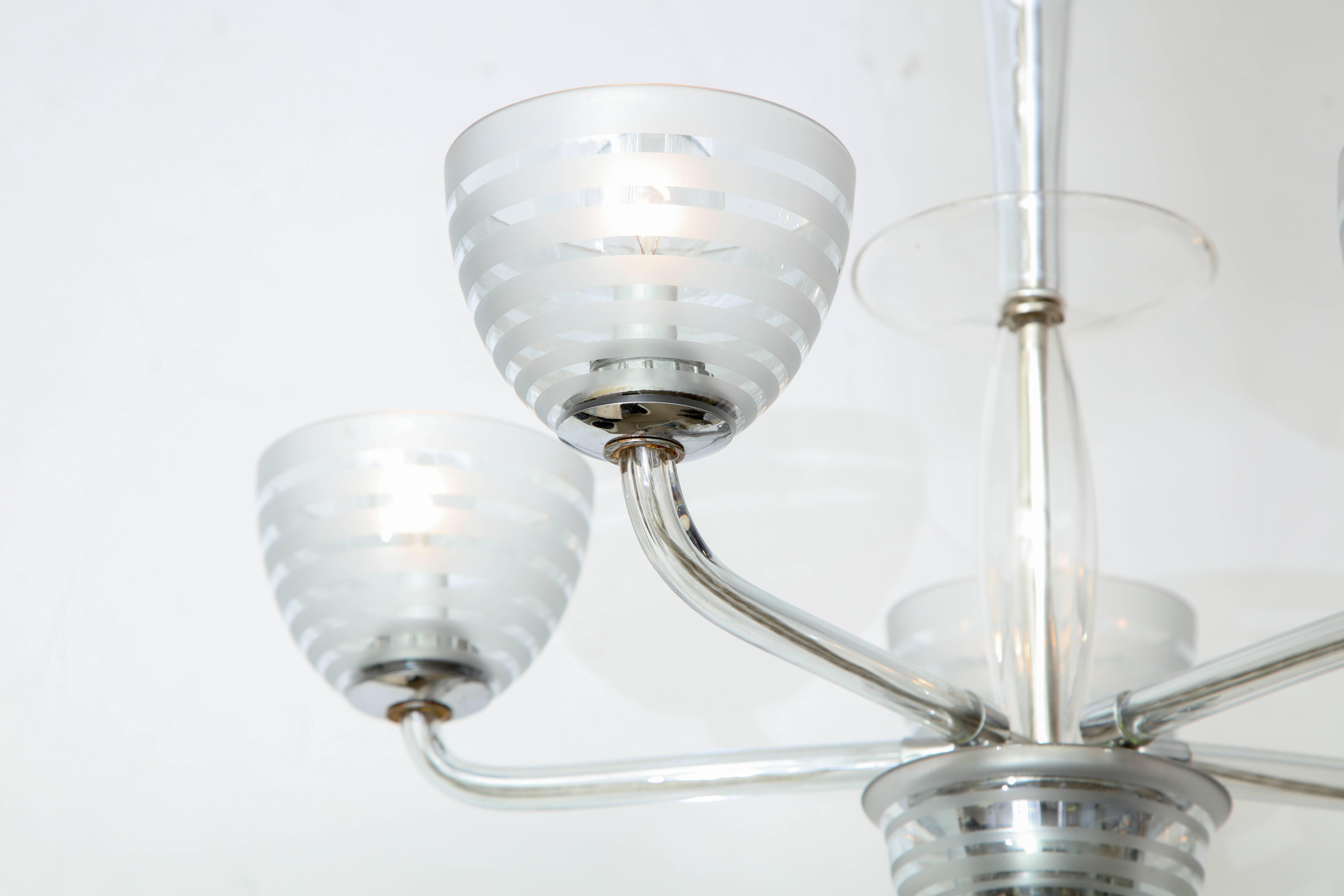 A five-arm chandelier in a glass featuring five globes with 