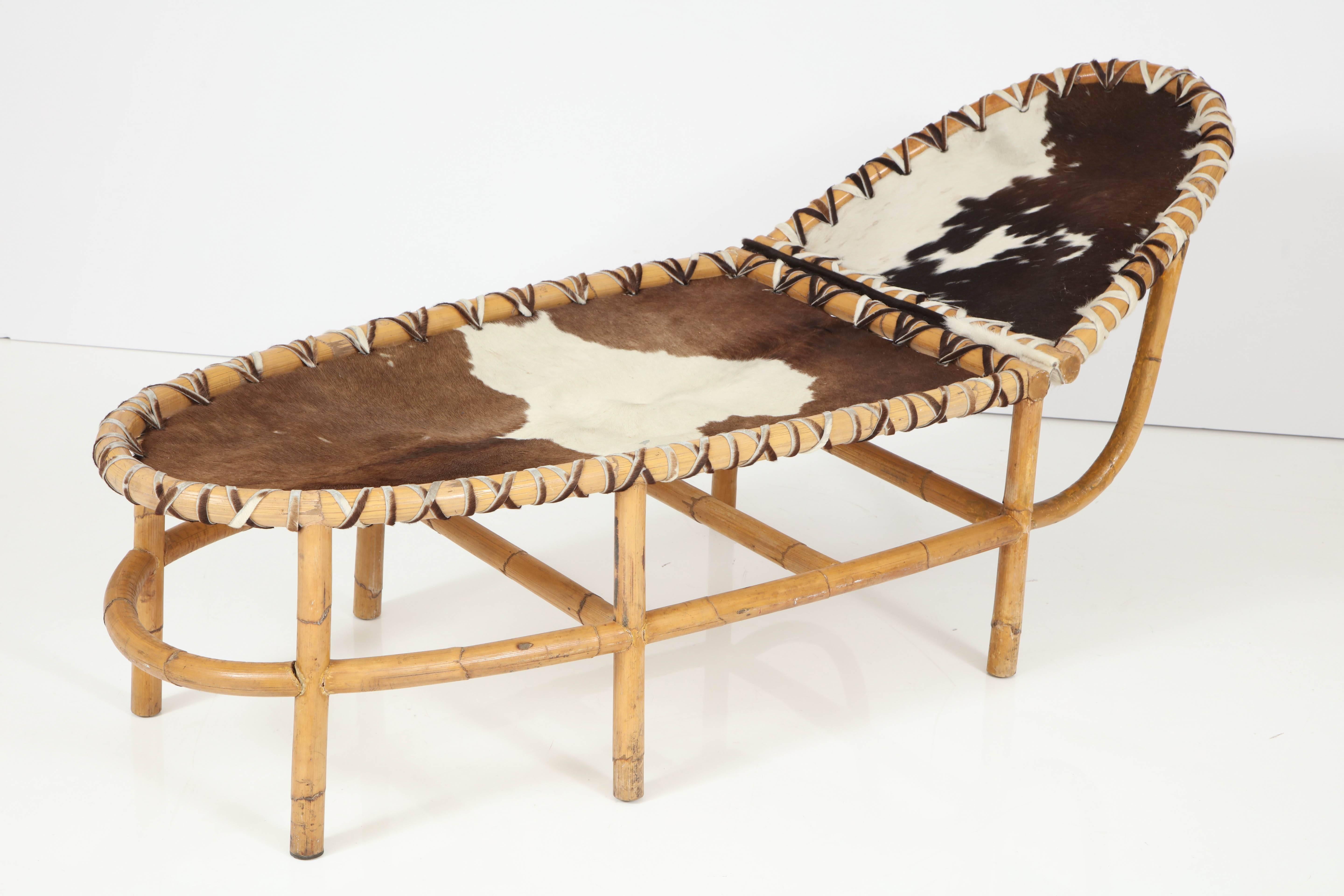 An unusual bamboo and cowhide chaise, all original and vintage, the price includes full restoration.
 