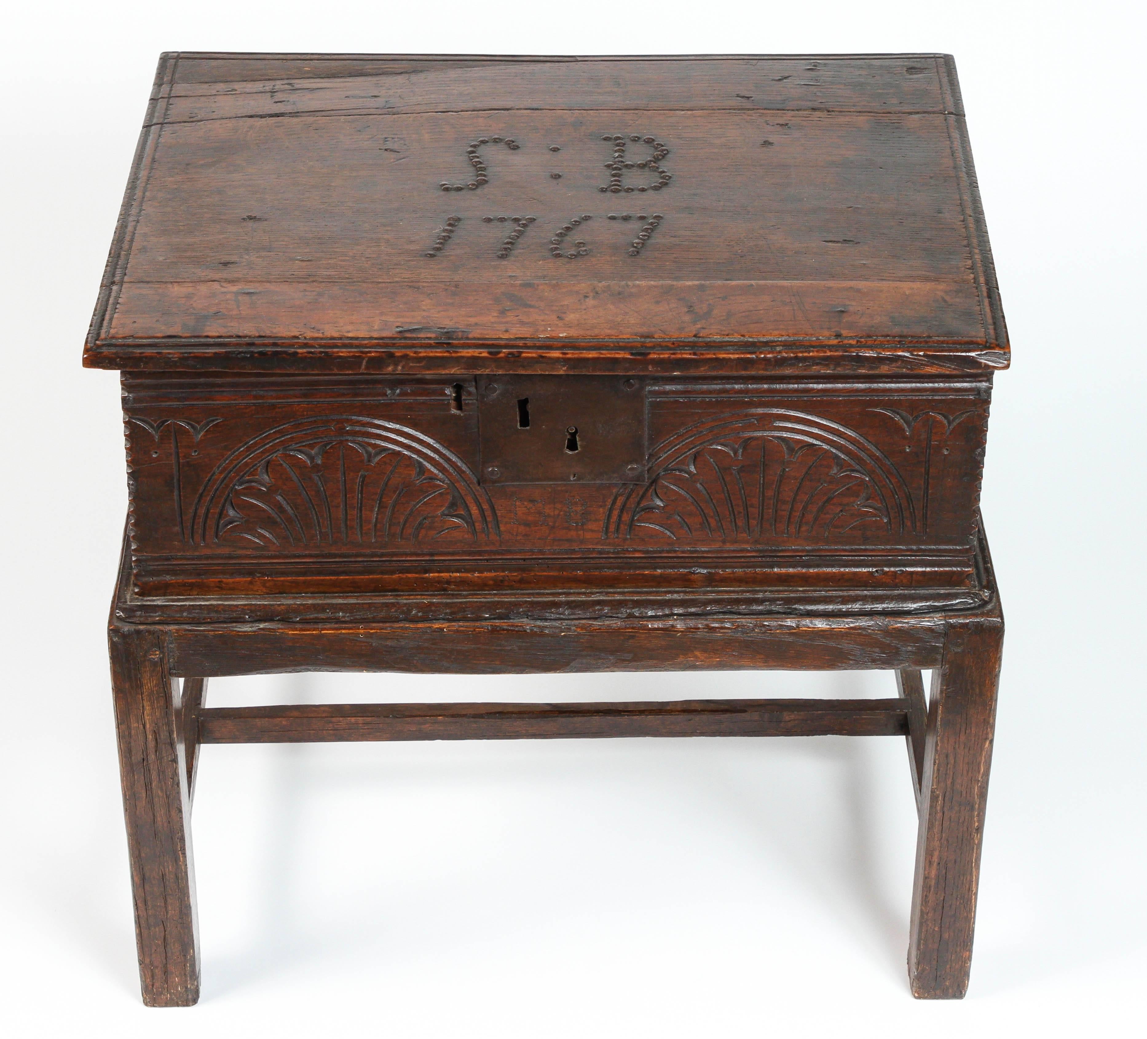 Beautifully carved English oak Bible box dated 1767, at top of box along with the initials S.B.
the box sits on a stand created at a later date.