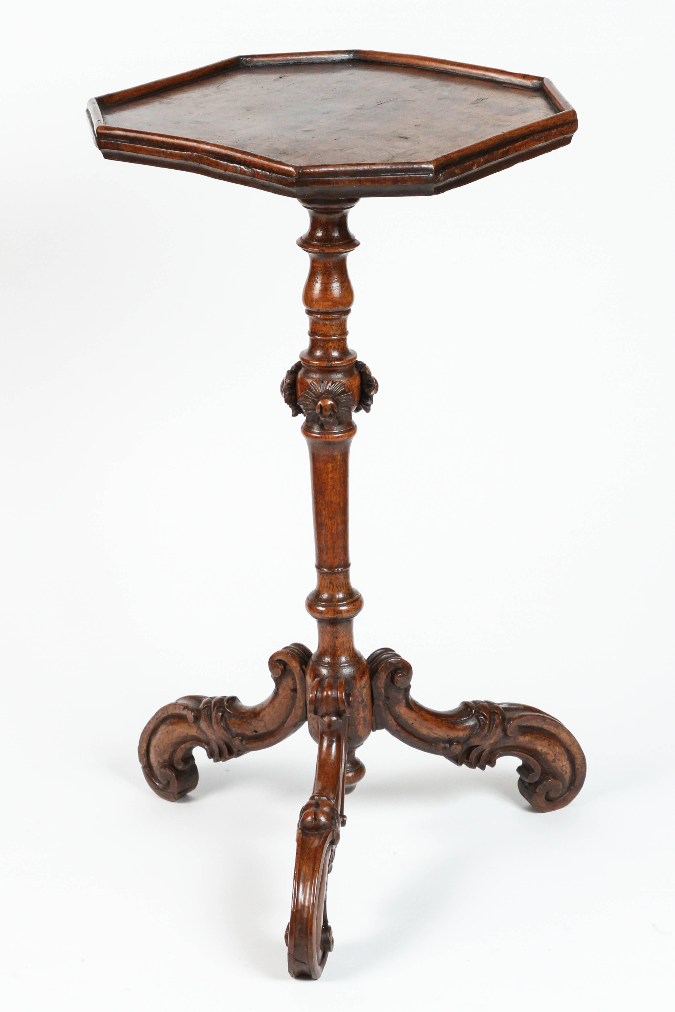 A pair of delicately carved Venetian walnut candlestands from the 18th century the stand sits on a beautifully detailed Rococo tripod-legged base.