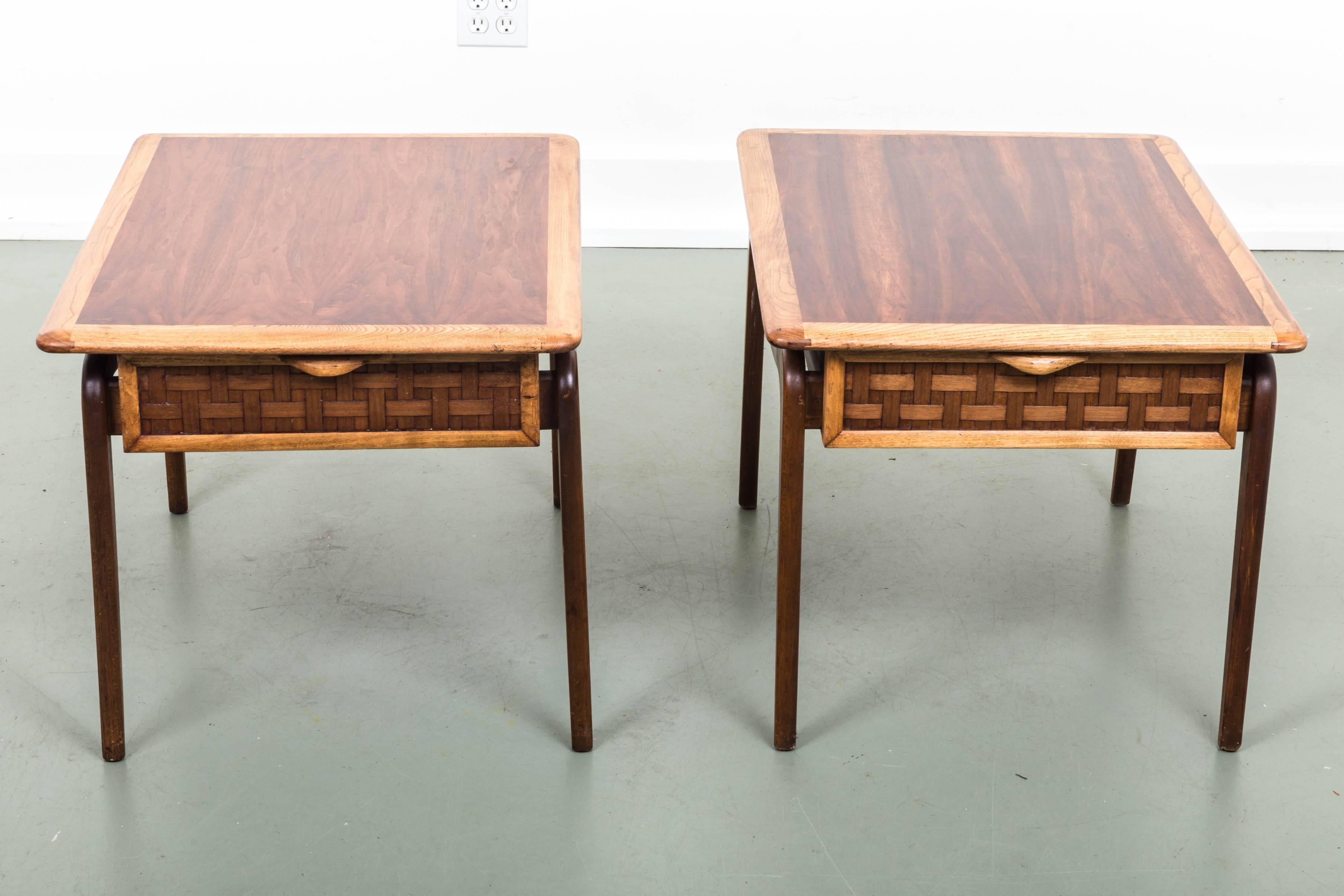 Pair of midcentury side tables, walnut and oak with basketweave fronted drawer, brass ball accents over tapered legs.