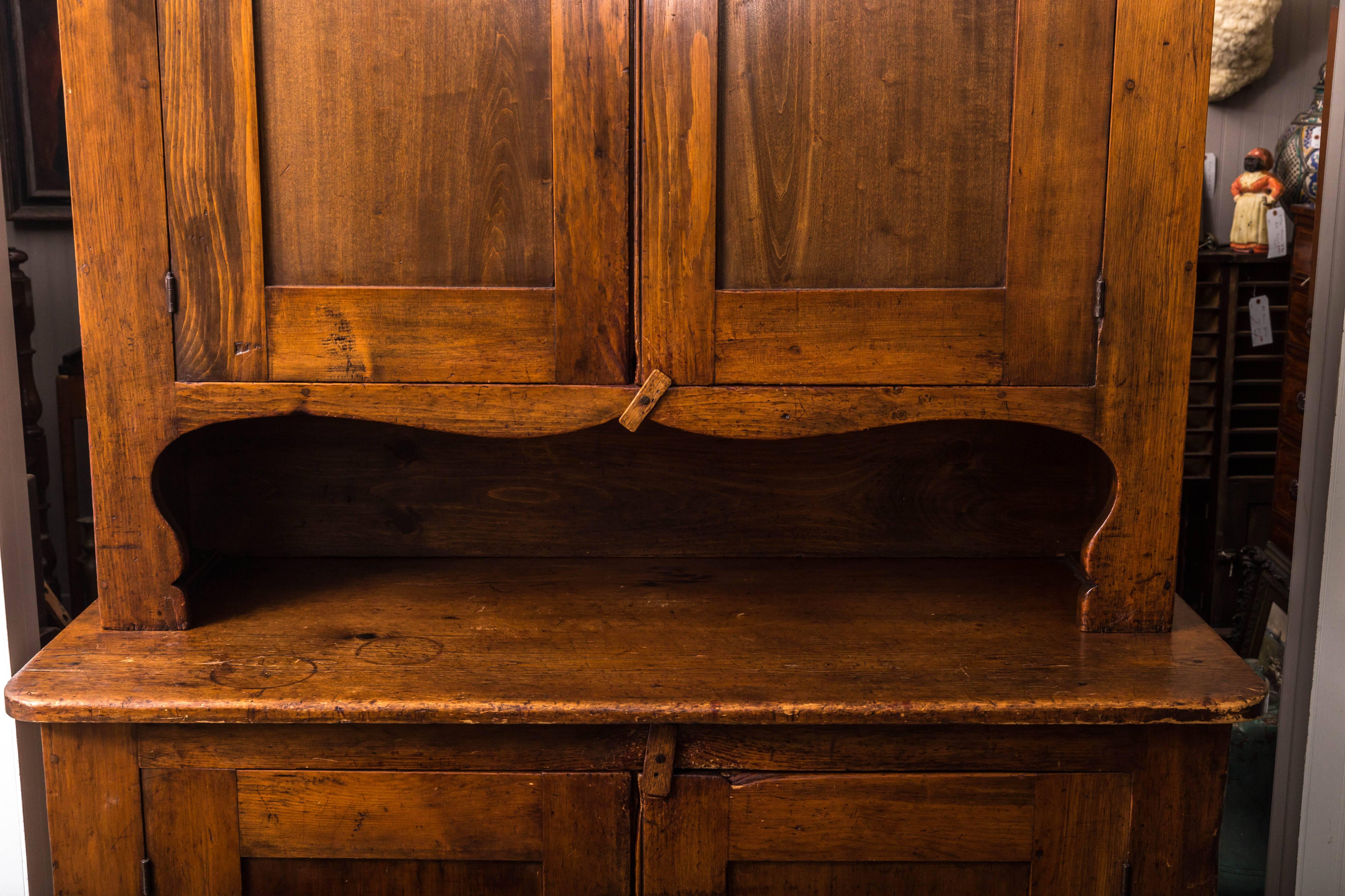 Antique pine step-back cupboard, Pennsylvania. Two door, three shelf interior. Simple border design over two door three shelf base. Top cupboard on wonderful serpentine base. Excellent age and patina.