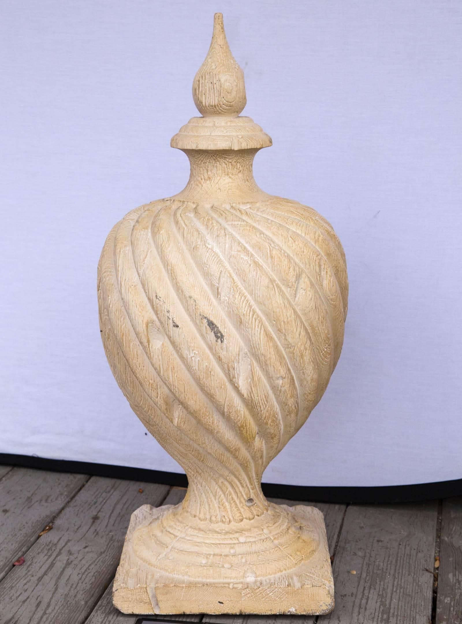 Carved twisted bulbous form upon a square base. Topped with a pointed uncarved finial. Designed from an earlier finial of Italian make. The base measuring 11 x 11.
Holes and wear to resemble earlier carved wood finials.