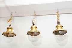 Brass and Glass Globe Pendant Lights, France, circa 1950s