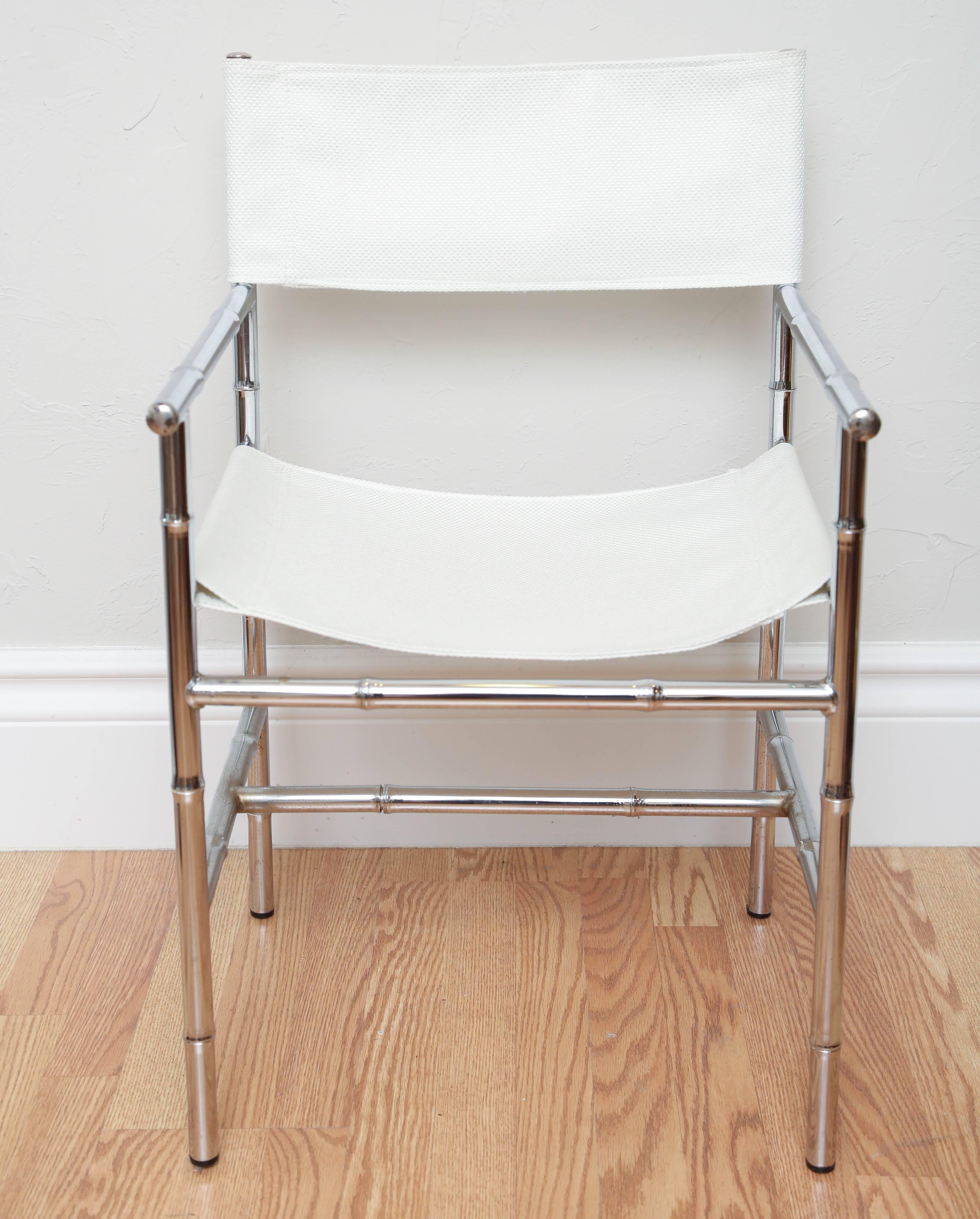 Set of four Mid-Century Modern chrome faux bamboo director's chairs with new white textured fabric.