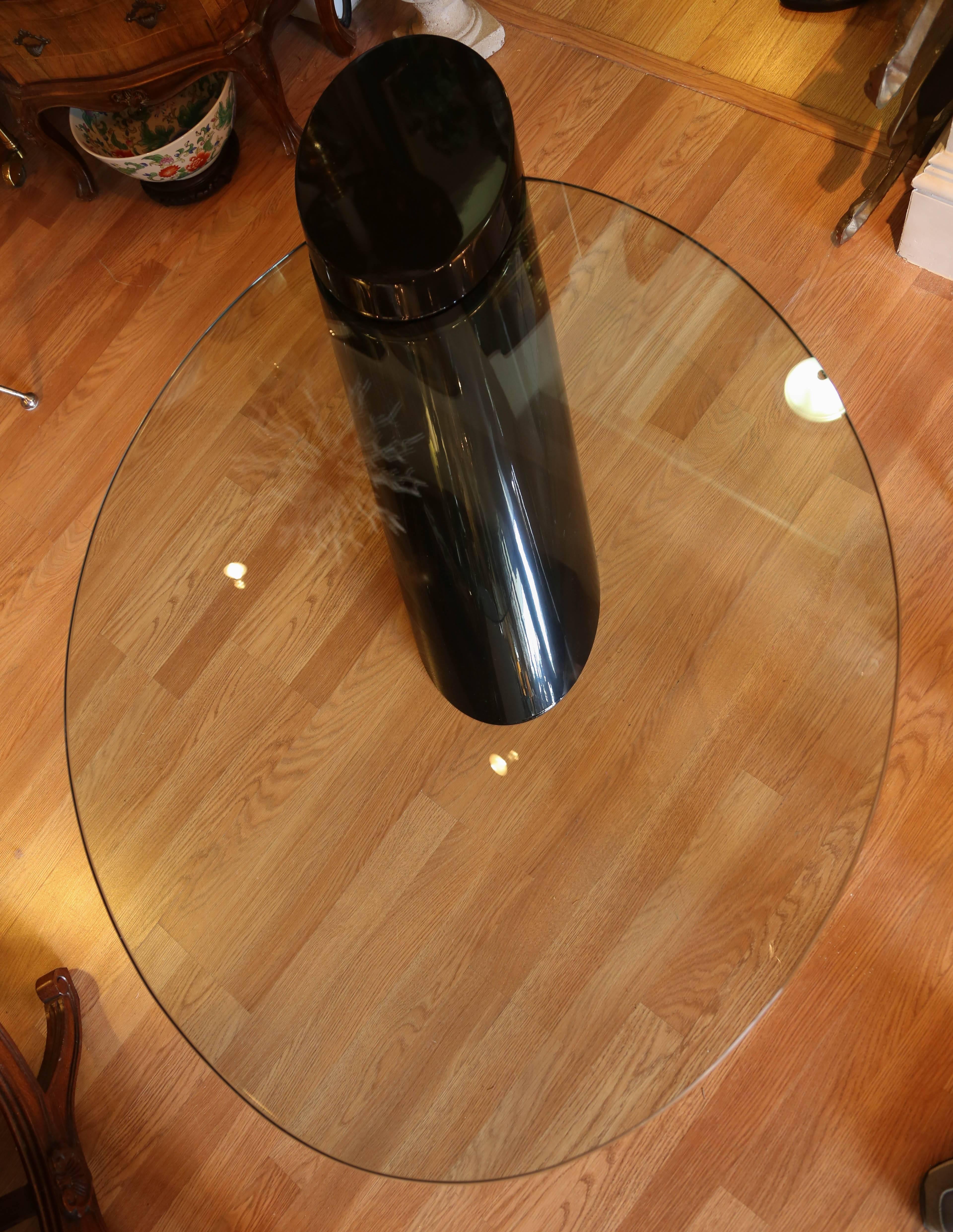 Coffee table with black lacquer base and counter balanced oval cantilevered glass by J. Wade Beam for Brueton.