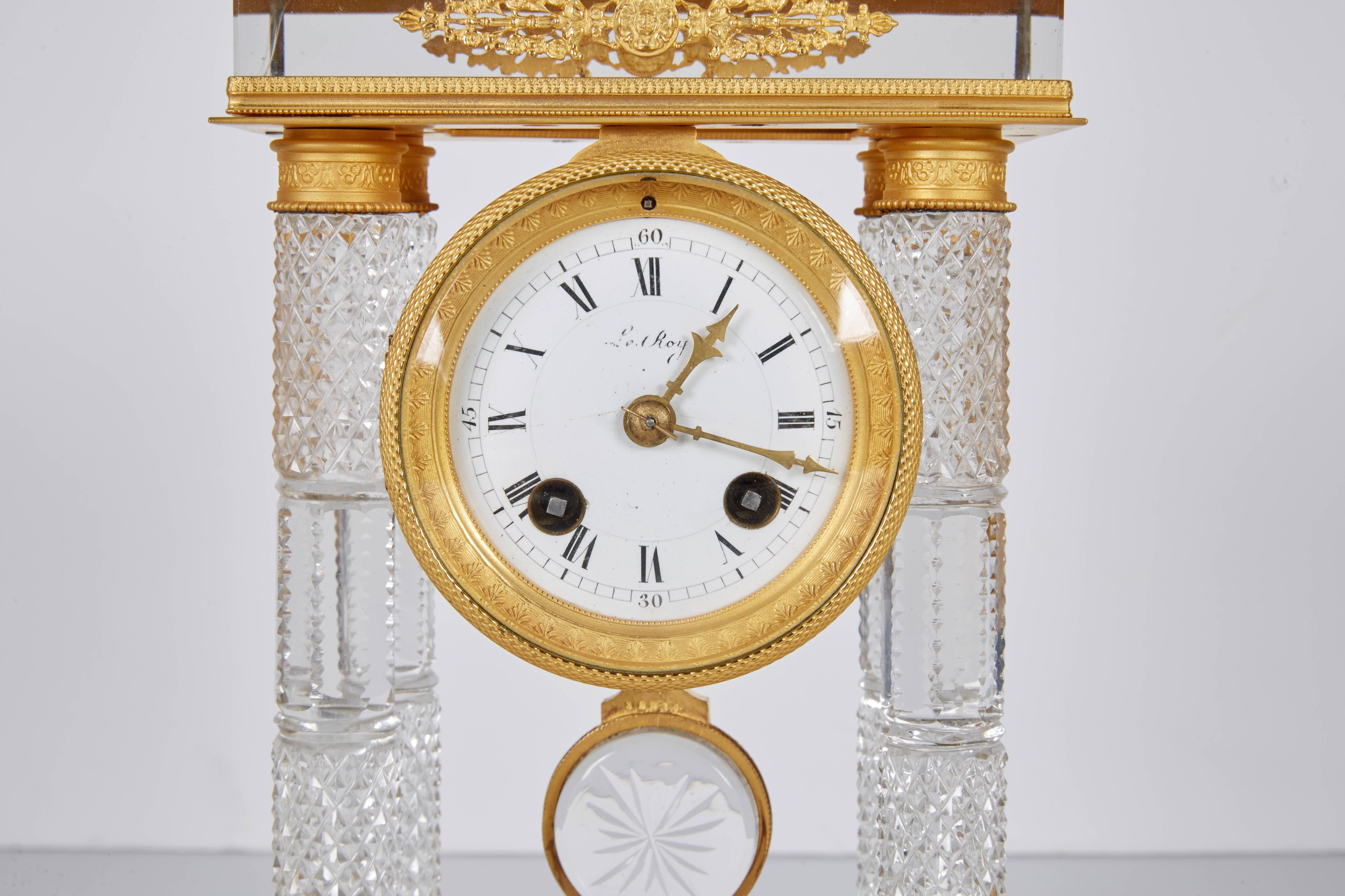 An exquisite French gilt bronze and crystal glass clock set garniture, attributed to Cristalleries De Baccarat.

A clock and a pair of candlesticks. 
Three pieces total.

19th century.

Very exquisite detail to the bronze mounts. Glass