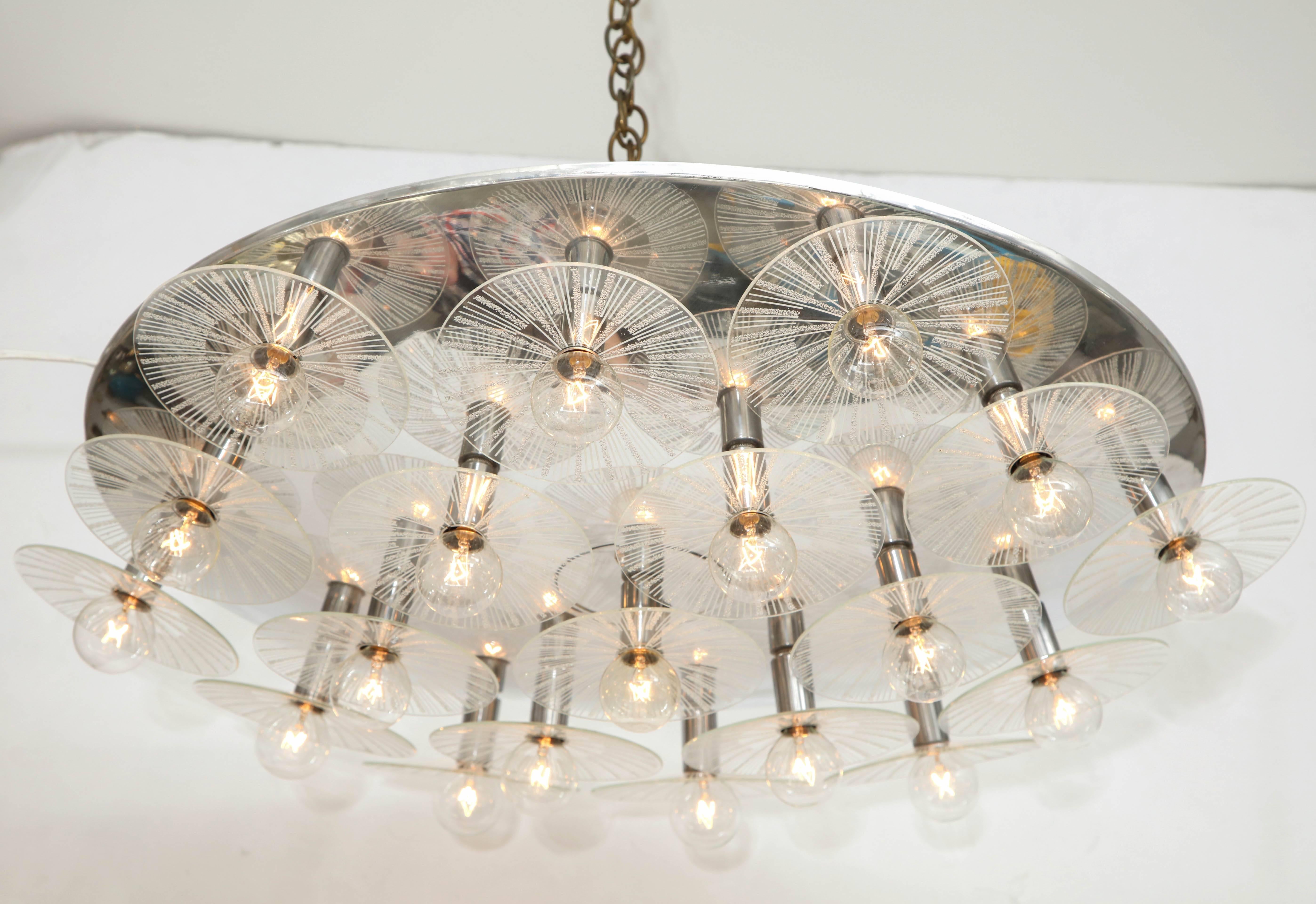 Fabulous, 1970s flush mount / sconce by Lightolier.
The polished chrome armature supports 19 glass disc elements with a radiating pattern each individually illuminated by their own light source.
The fixture has been newly rewired for the US and