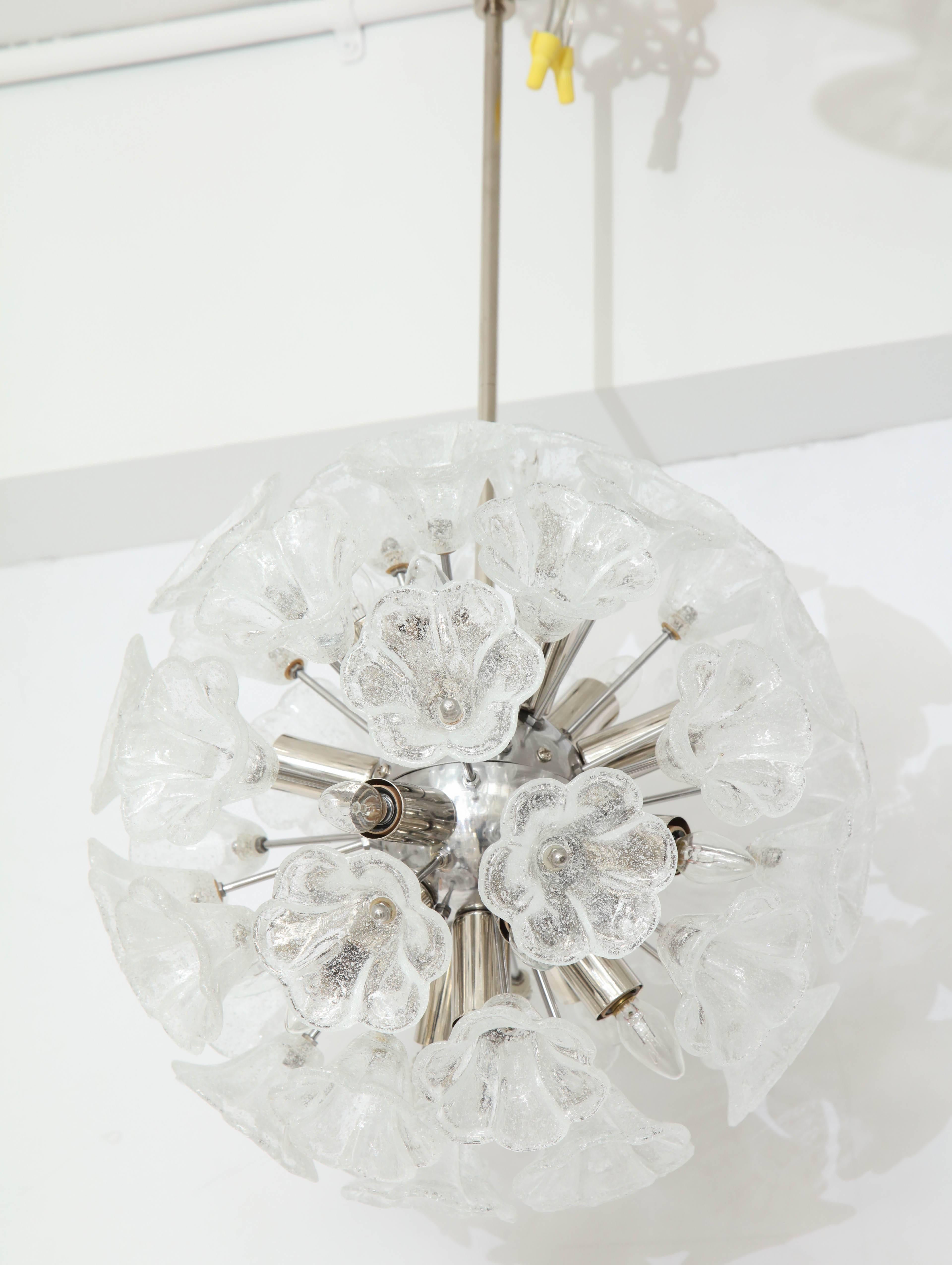 Elegant Italian floral Sputnik chandelier.
The chrome armature supports clear and opaque floral glass elements with light bulbs nestled in between.
The fixture has been newly rewired for the US with candelabra light sockets and comes complete with a