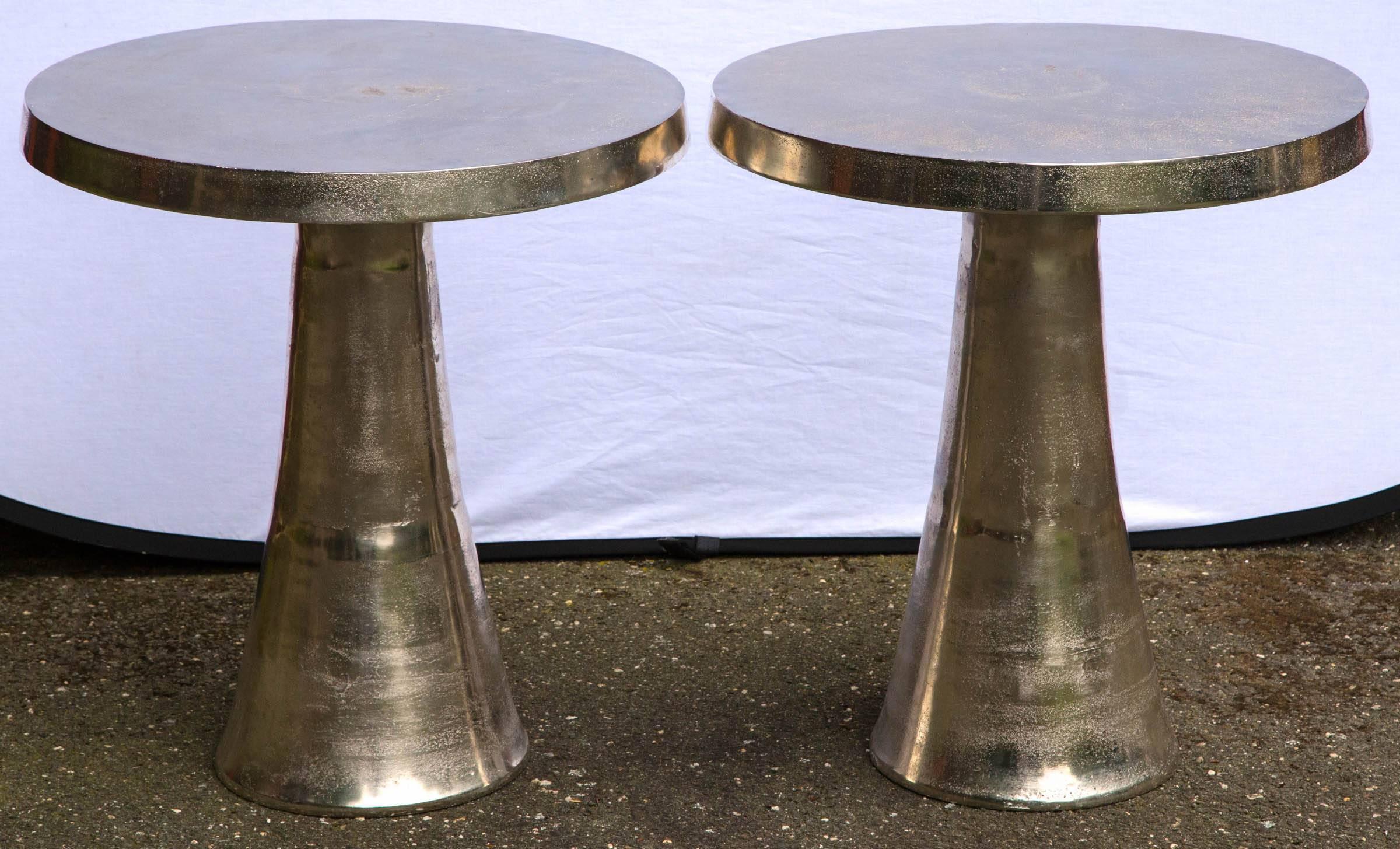 Unique pair of round polished stainless steel tables, with conical base.