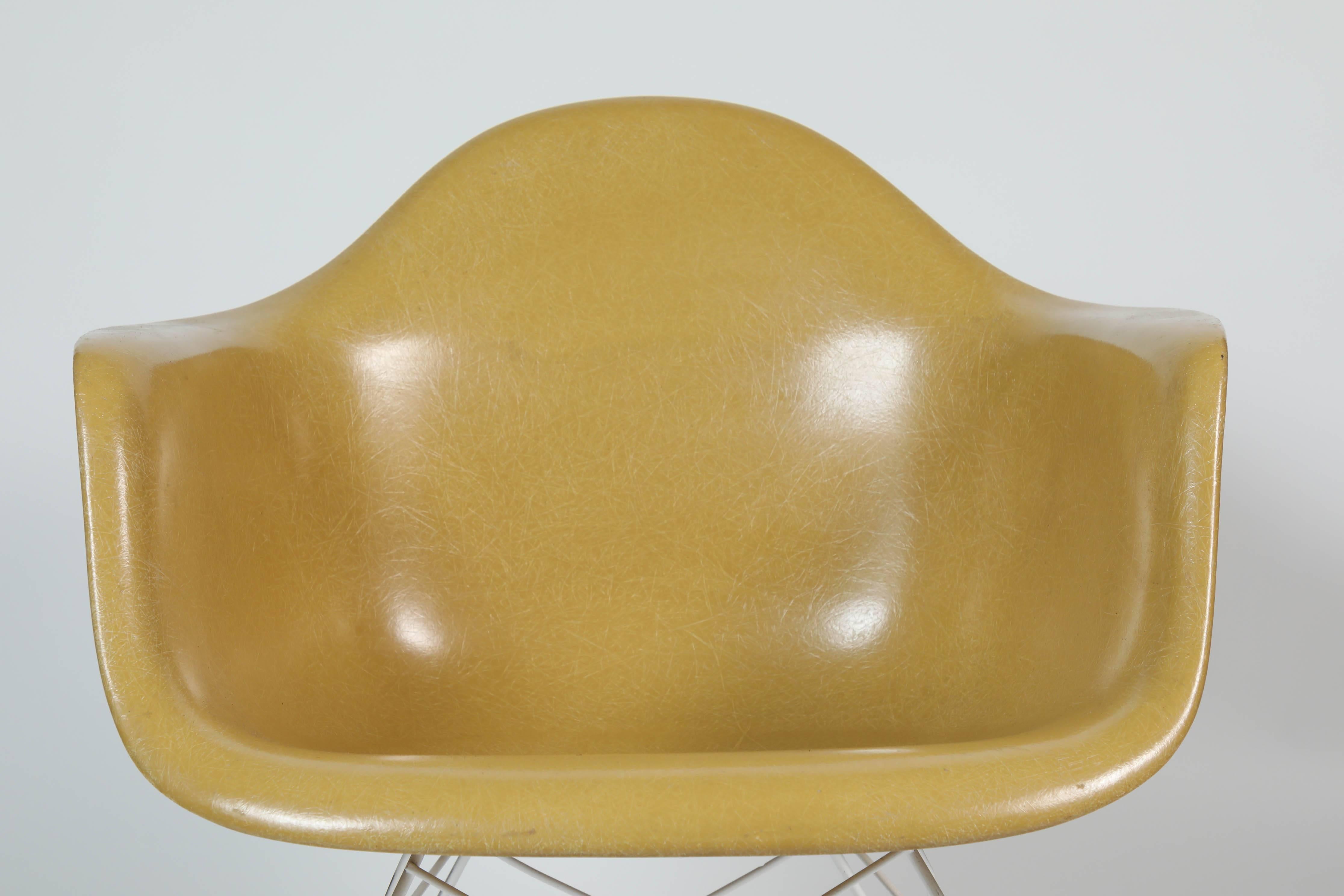 Restored pair of Eames Herman Miller fiberglass shell armchairs with metal Eiffel tower base. Original Herman Miller mark on bottom.