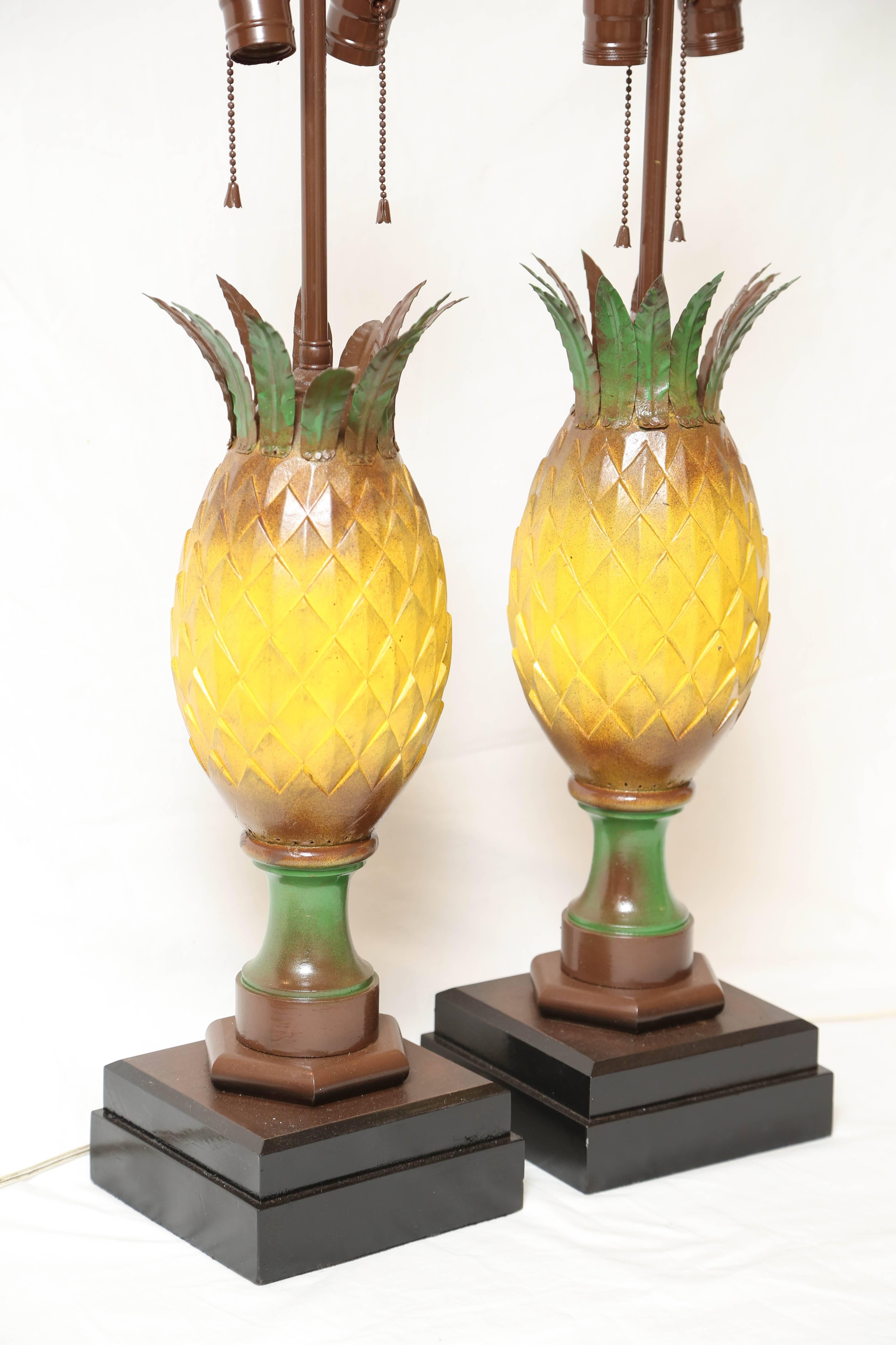 A whimsical pair of handmade vintage tole decorated carved wood pineapples vibrantly painted and dramatic in form.
An old Palm Beach find.