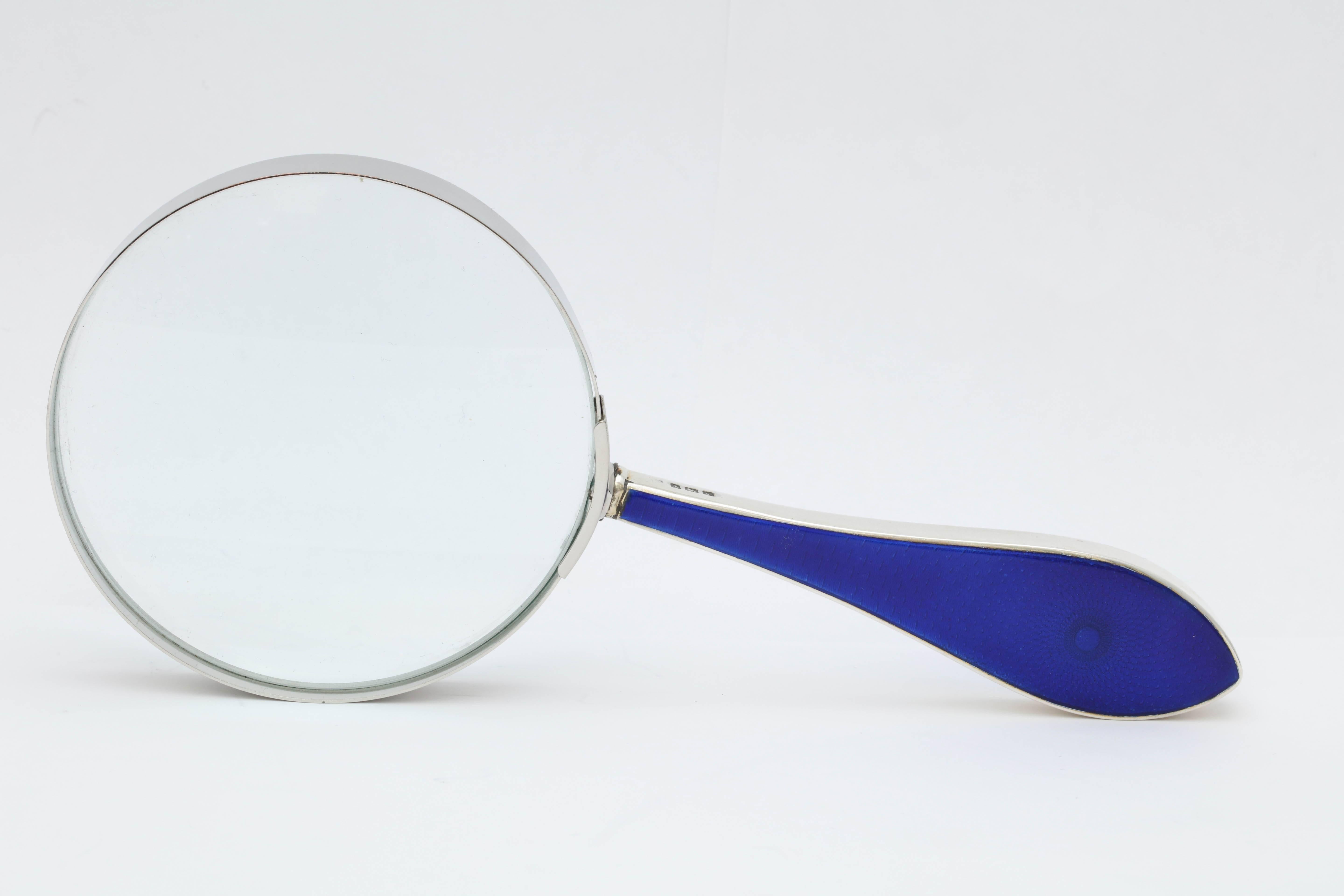 Large, Art Deco, sterling silver-mounted deep cobalt blue guilloche enamel magnifying glass, Birmingham, England, 1923. Measures: 8 1/2 inches long x 3 3/4 diameter of actual magnifying glass itself, which has a metal rim. Sterling silver has deep