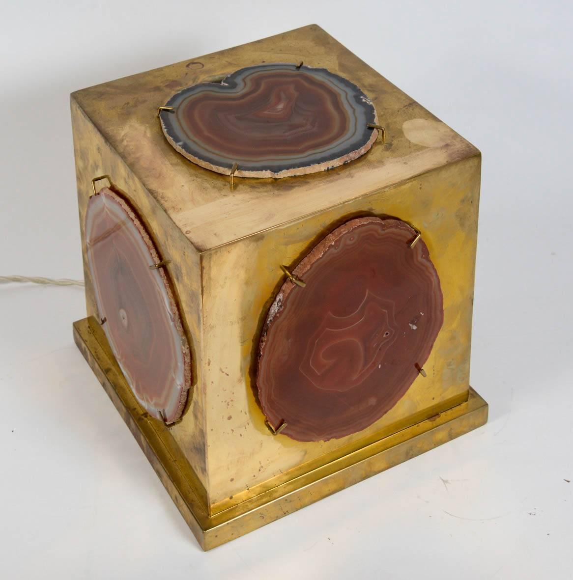 Square table lamp made of five brass panels each covered by an agate slice letting the light through.