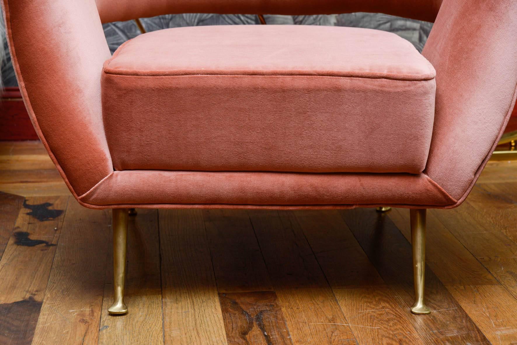Pair of vintage armchairs with brass legs, upholstered with salmon pink velvet.