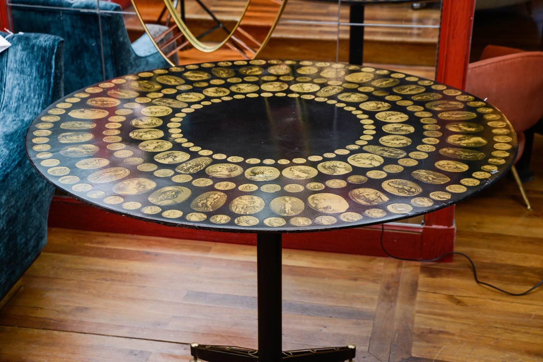Pedestal with antic black and gold medallions from Piero Fornasetti.
