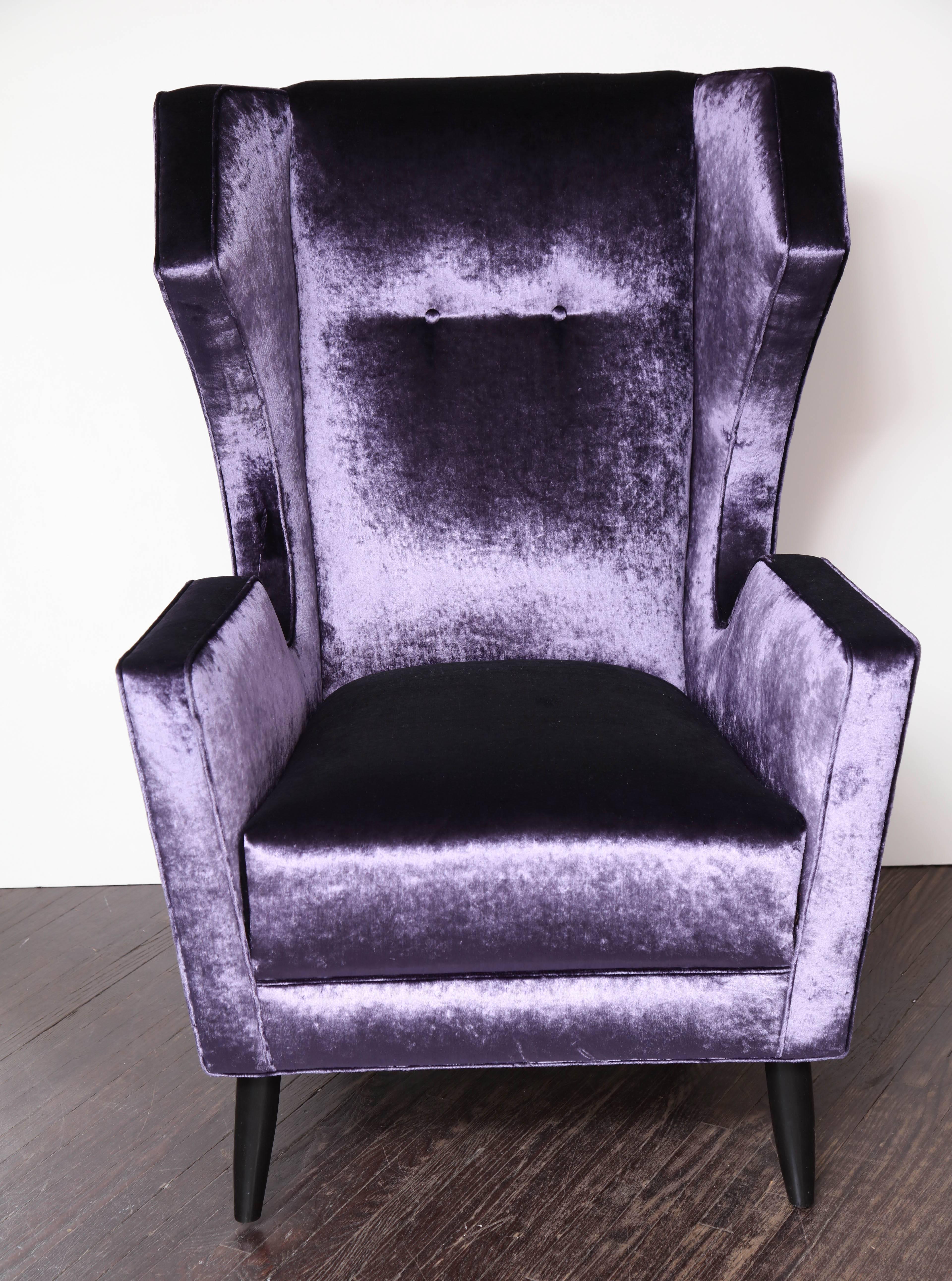 Pair of custom wing chairs in the style of Gio Ponti upholstered in Romo amethyst velvet.