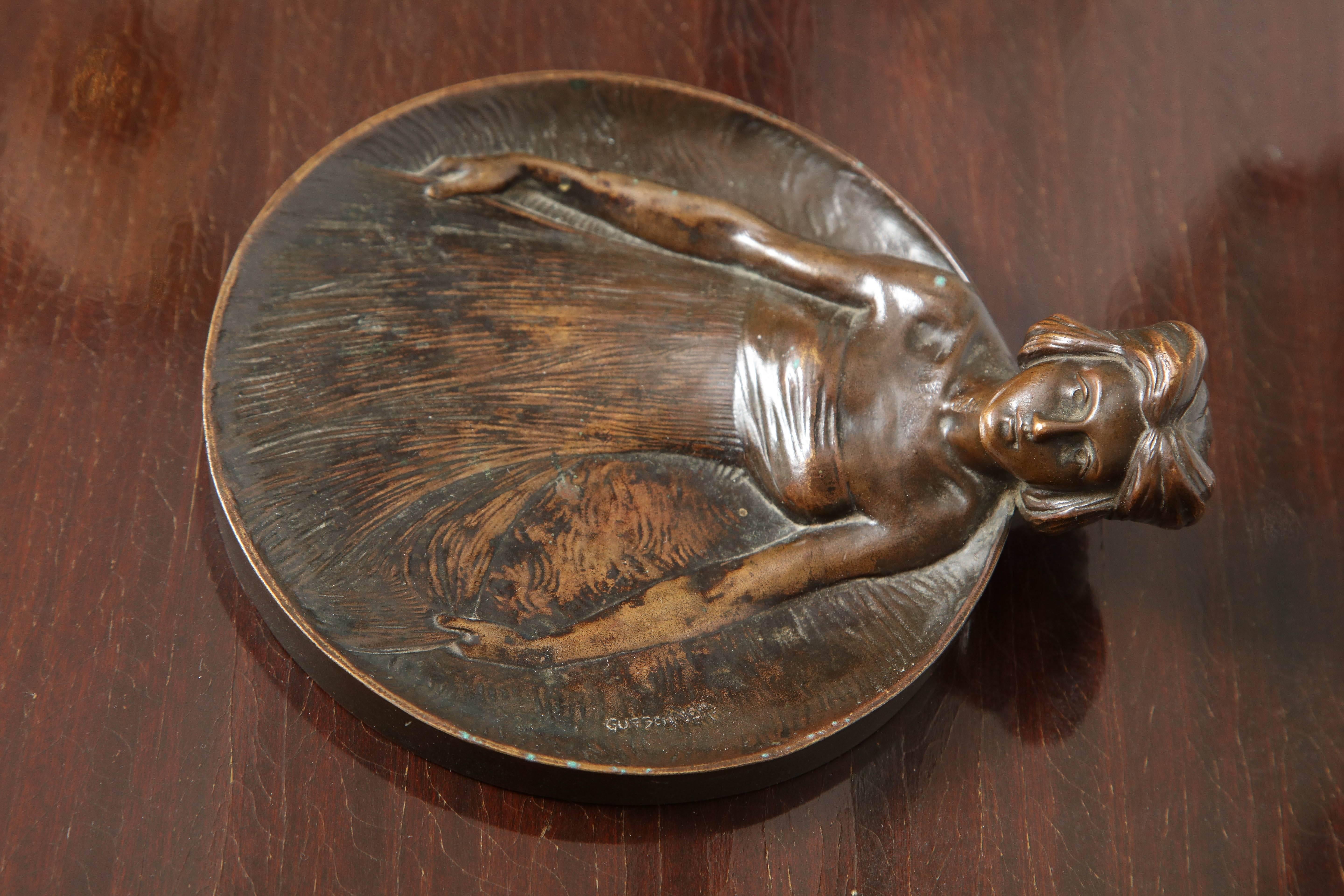Bronze Art Nouveau tray in the form of a woman designed by Gustav Gurschner made in Vienna, Austria 1900. Signed  Gurschner on the insider boarder with the foundry mark on the outer rim, bottom is marked “Mod. N92”
 
Gustav Gurschner (1873–1970) was