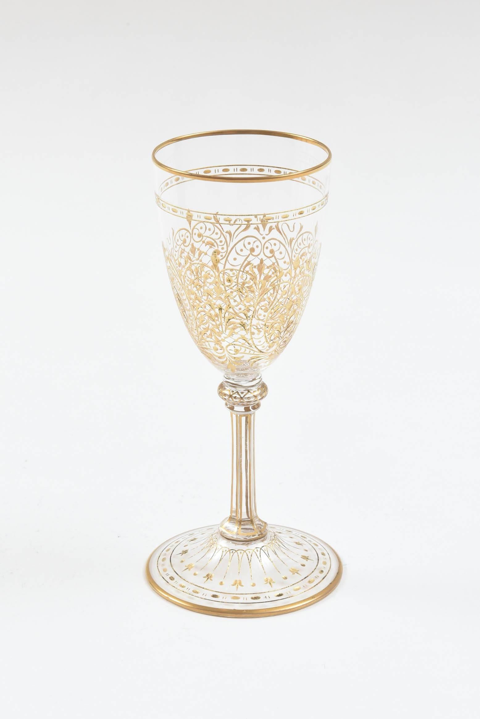 An elegant service with many pieces in a beautifully blown cut crystal design with hand decorated 24-karat gold painstakingly hand applied everywhere. We attribute this set to Moser, The Glass of Kings due to its shape and intricate design and