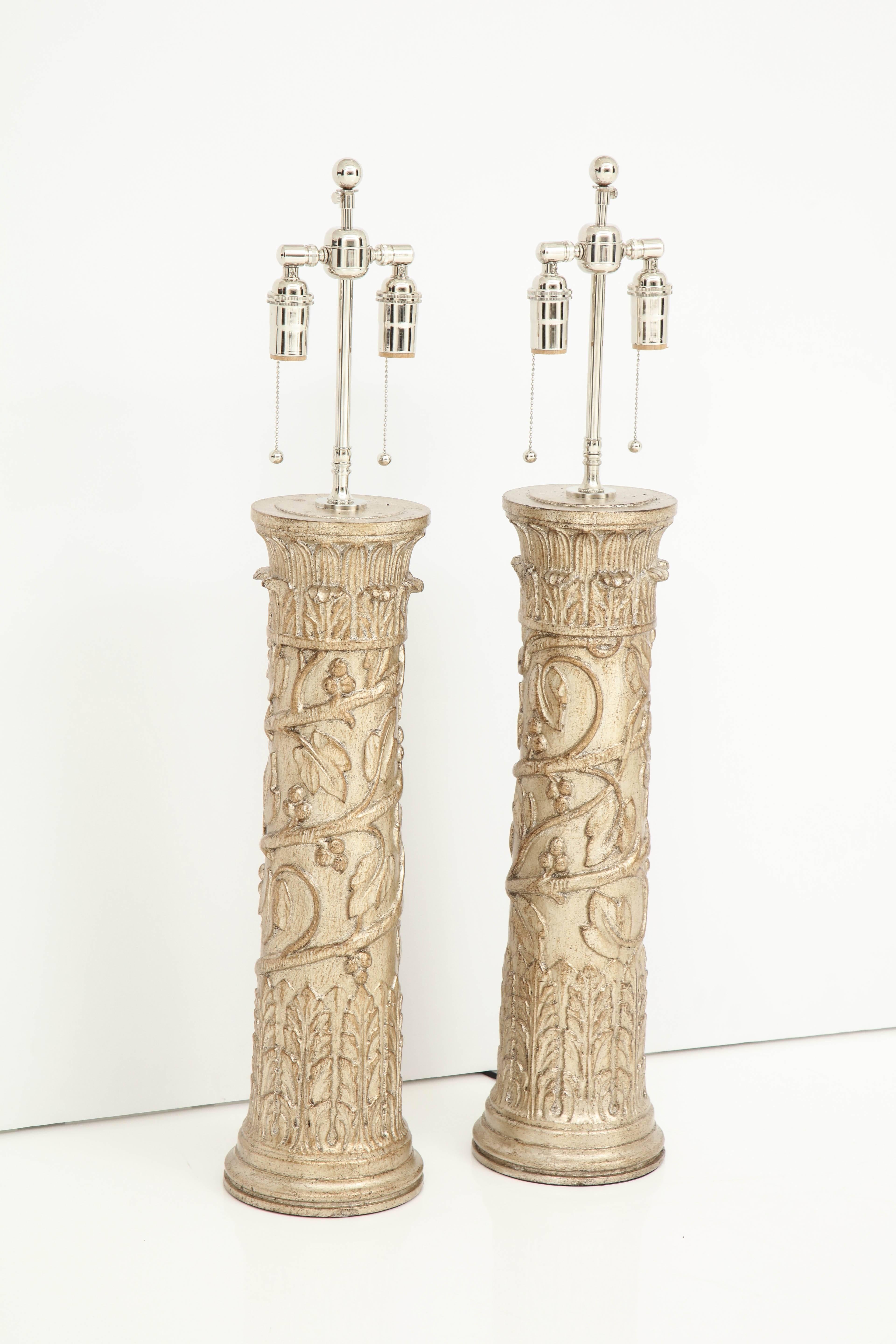 Pair of column lamps by James Mont.
The lamps have a beautiful decorative design with a glazed silver leaf finish.
They have been newly rewired for the US with polished nickel double clusters that take standard light bulbs.
