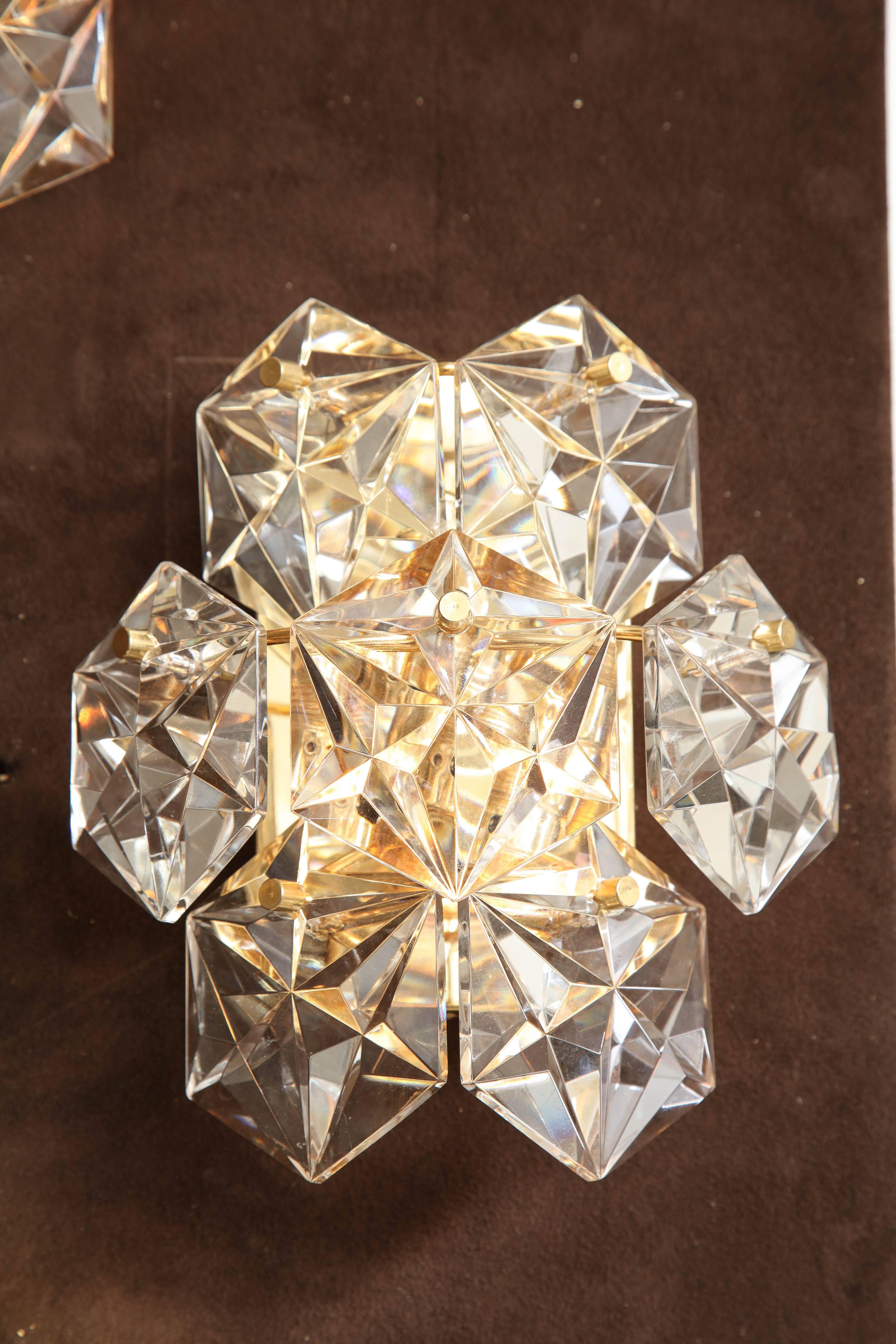 Elegant pair of faceted crystal sconces on polished 22-karat gold plated backplates.
Each sconce has seven crystal elements and two-light sources that have been newly rewired.