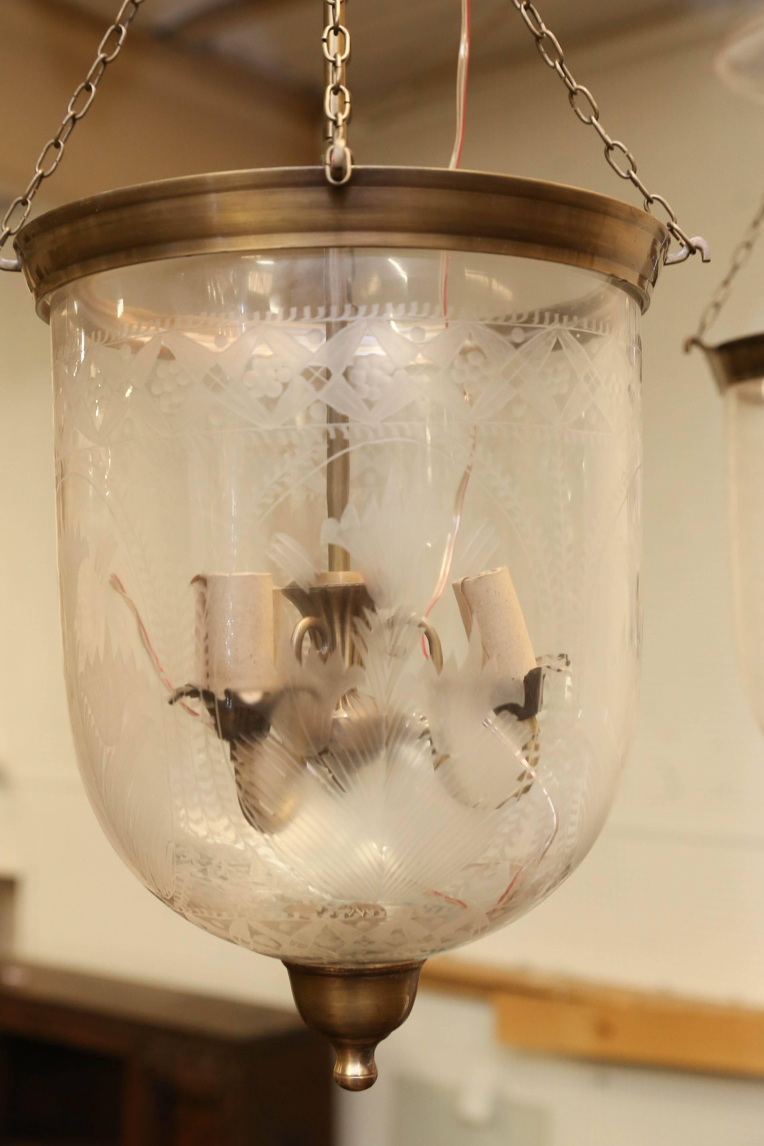 This is a complete hand etched bell jar lantern with hand cast brass hardware. Originally lantern like this one was used for burning whale oil in Europe. Since whale oil emitted thick smoke, glass deflector was added to it. The jar is hand etched in