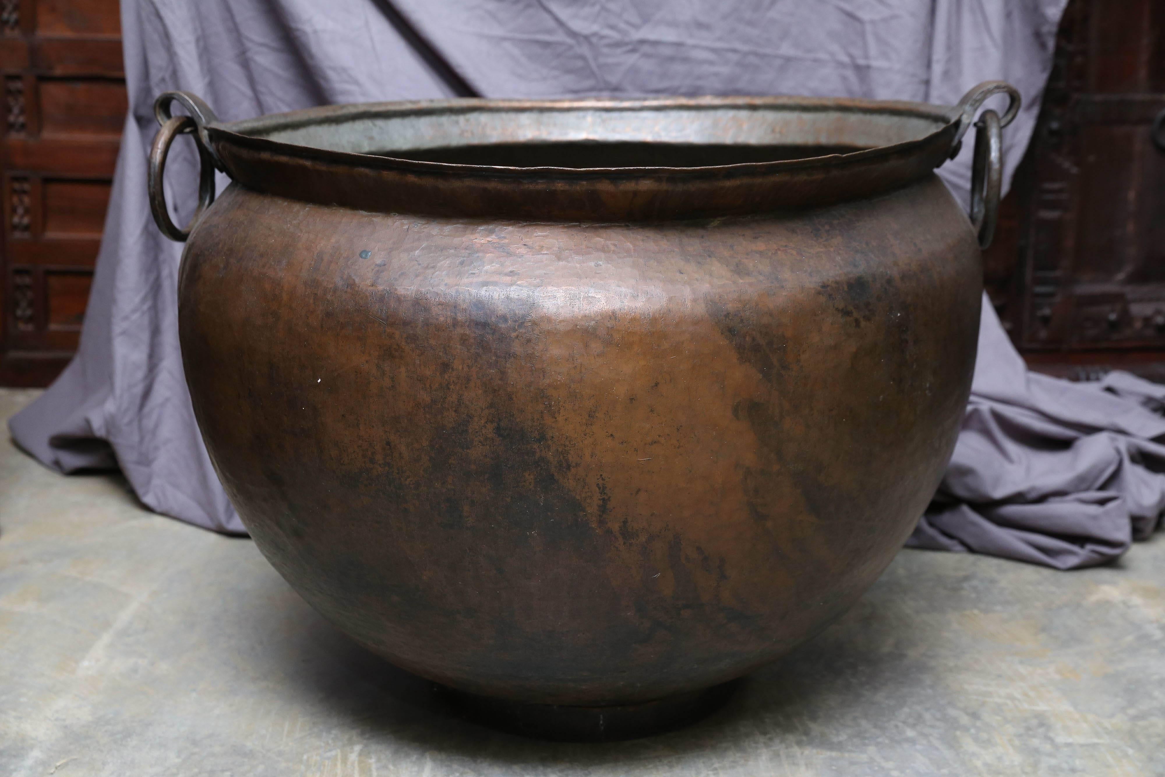 This large copper alloy vessel was used for cooking food for devotees who come to the temple for worship.
The food was prepared by burning firewood on makeshift oven. This large vessel was made by hammering thick copper alloy sheet and hand welding