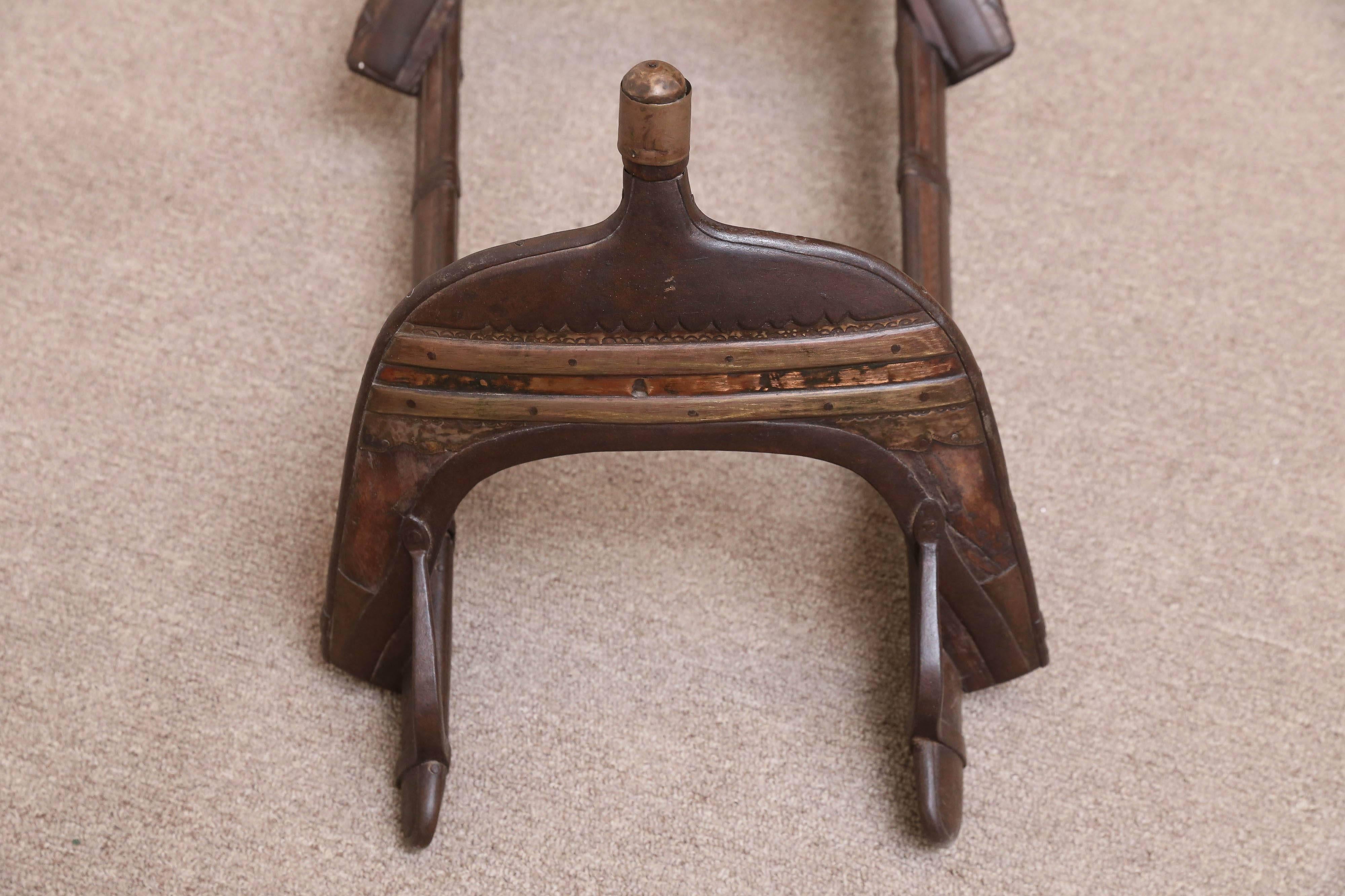 Finely crafted with teak wood, copper alloy and iron this was used to ride camels in the Dhar desert in India.
This seat will be placed over a thick mattress on the camel back and two people will ride on the camel.
Note the intricate copper alloy