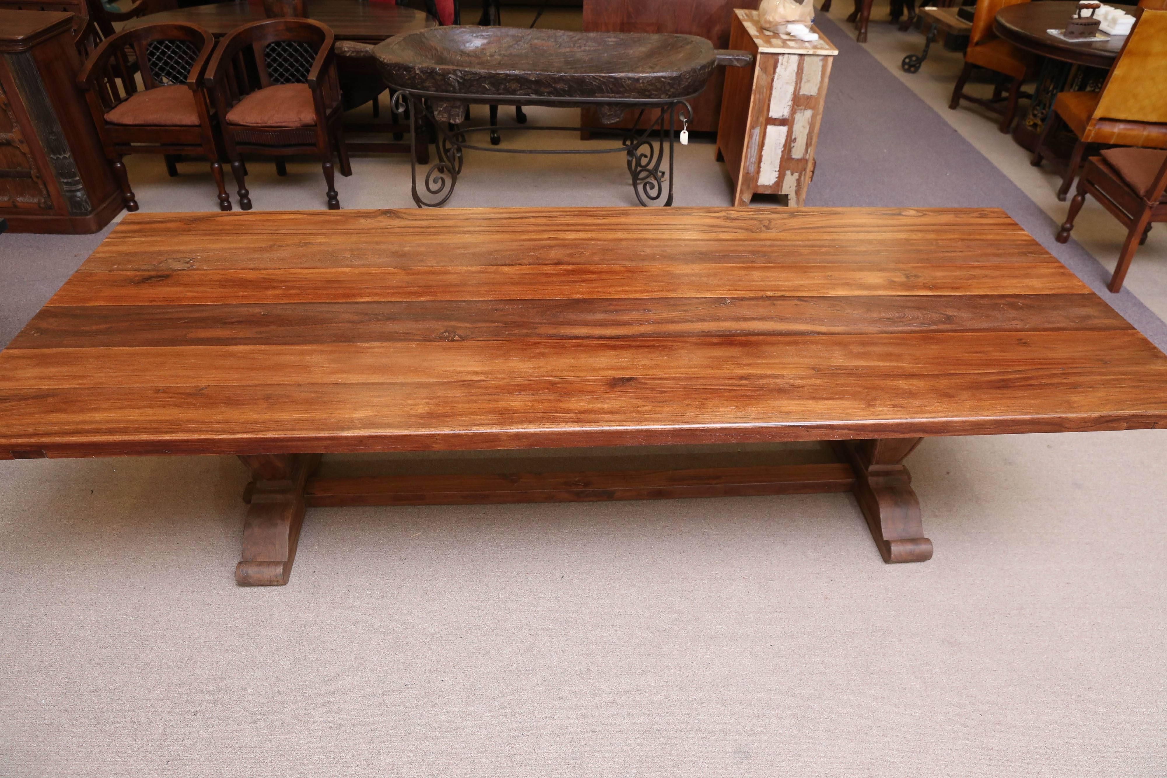 Teak wood slab of 2.3 inch was used all through for the top. Made in an era of wealth, economizing of wood or anything else was not on their plan. Though heavily made the table looks light and airy. The top is supported on each end by massive shaped