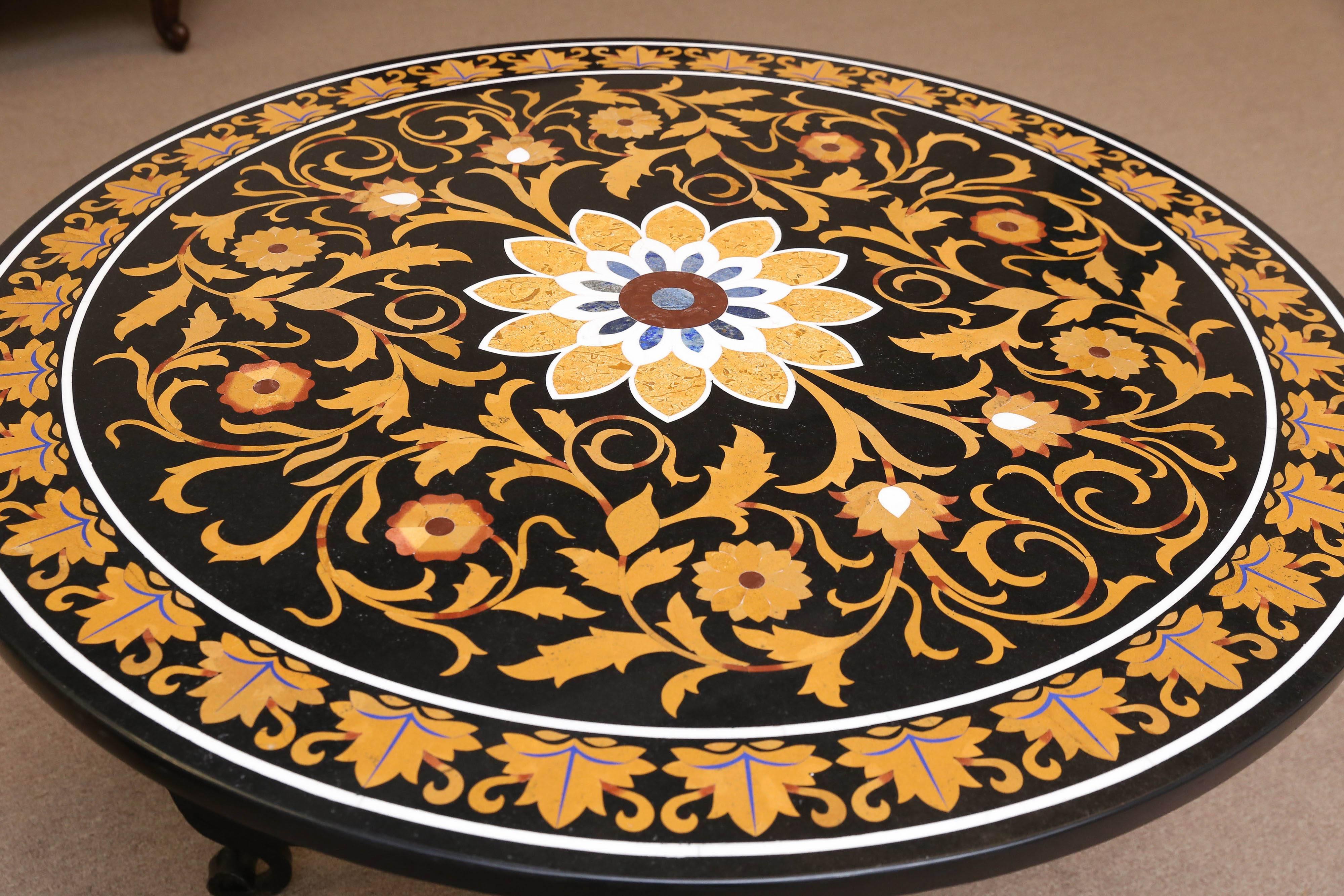 This entry table is exquisitely inlaid with semi-precious stones and other rare marbles. It is practically resistant to scratch. A great table by any standard. A hand-forged solid wrought iron base support the inlaid tabletop. It is a great entry