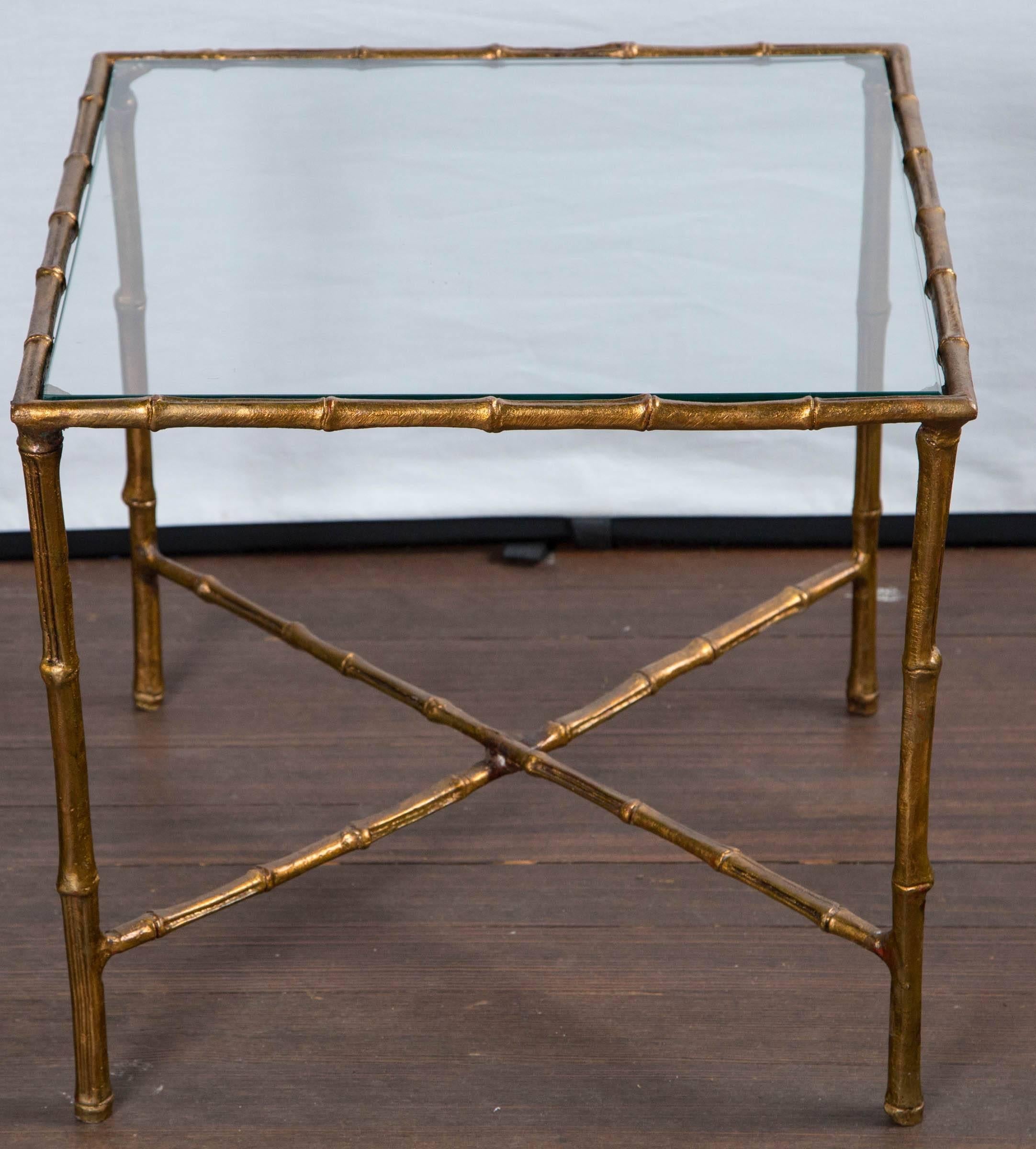 Vintage gilt metal. most likely brass, square faux bamboo tables with glass tops.
Nice weight