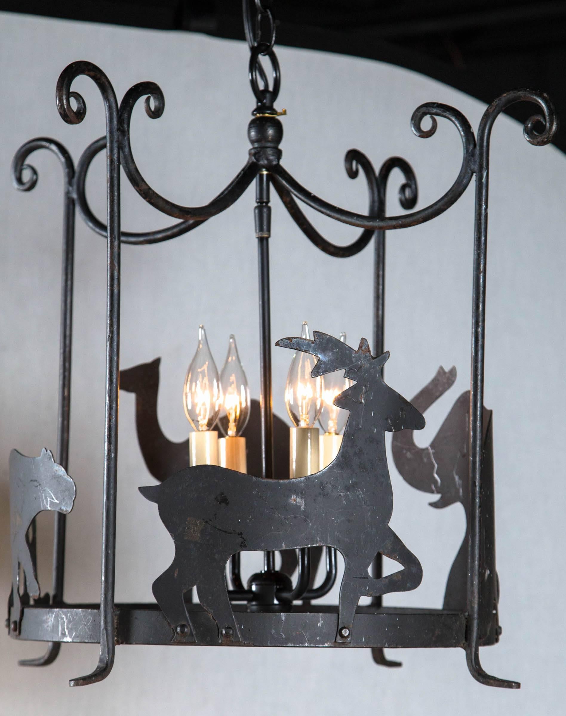 These charming pair of iron chandeliers would add the perfect touch of whimsy to any child's room, family room, or casual eating area. Complete with Elk, elephants, lions and camels and four interior lights. Newly wired and ready for any space in