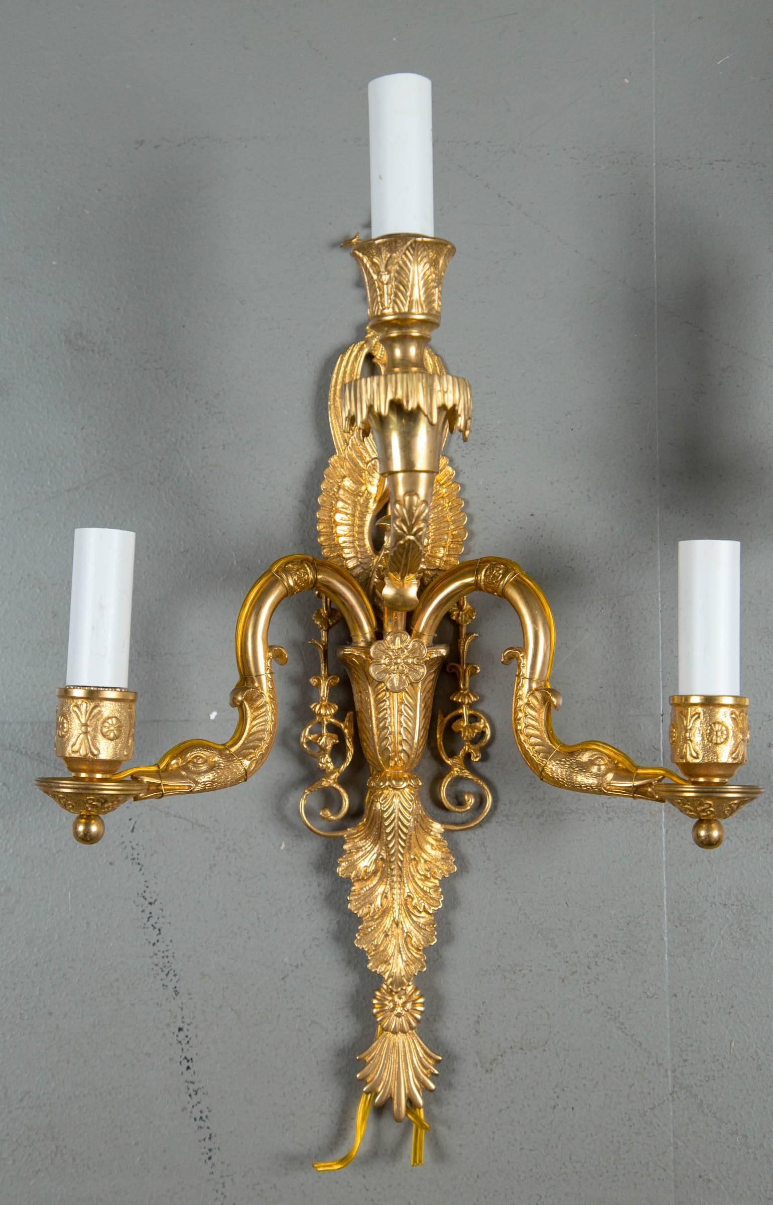 A pair of 1930 French Empire style sconces with three lights.