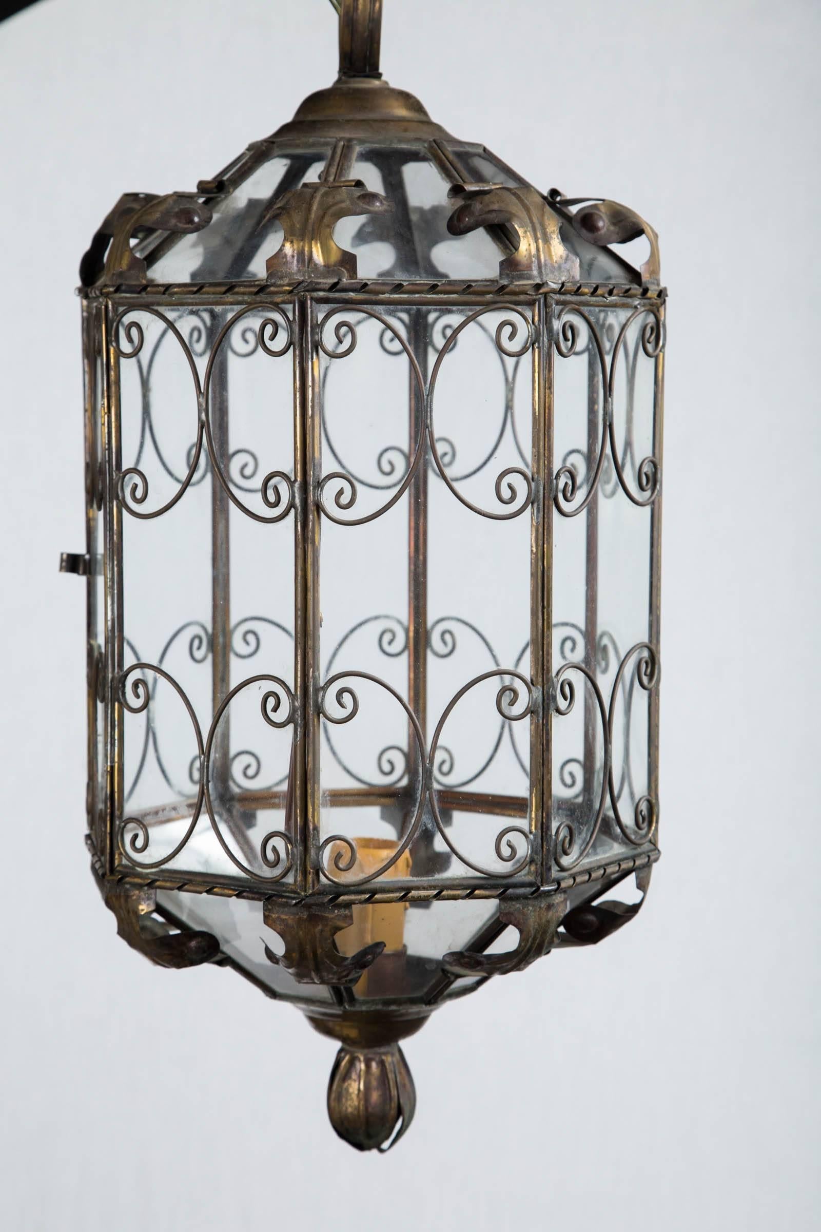 1940s octagonal Italian metal lantern electrified with on standard socket, original chain and canopy included. Delicate decoration makes this a lovely piece.