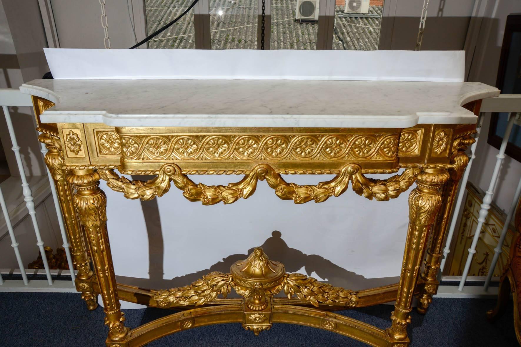 Sumptuous gilded wood console, topped with an amovible white marble.
Signed A M under a crown  

Signed by Andre Mercier.