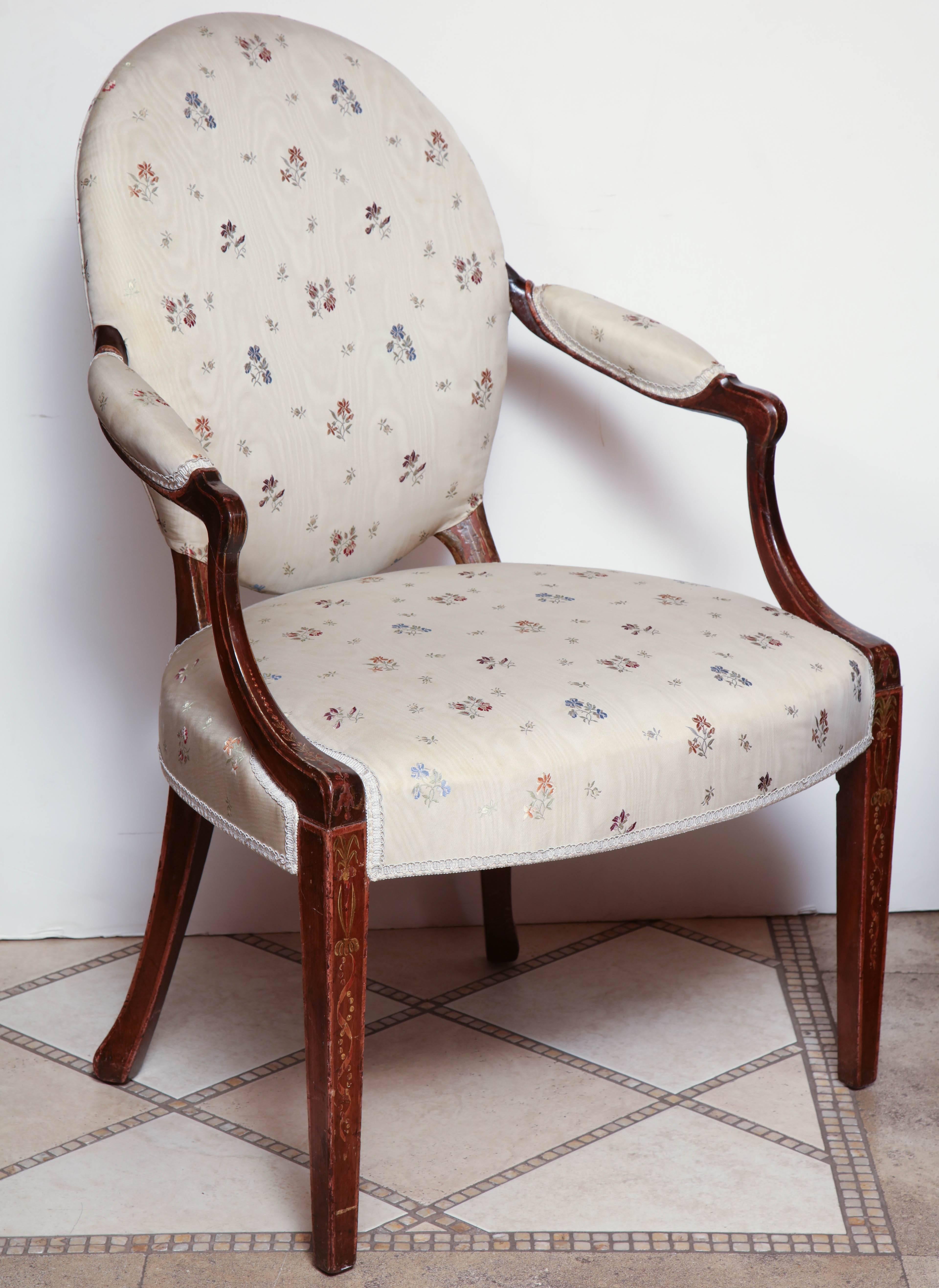 Pair of painted George III oval back open armchairs with stencilled neoclassic decoration of bowknots and ribbons.
