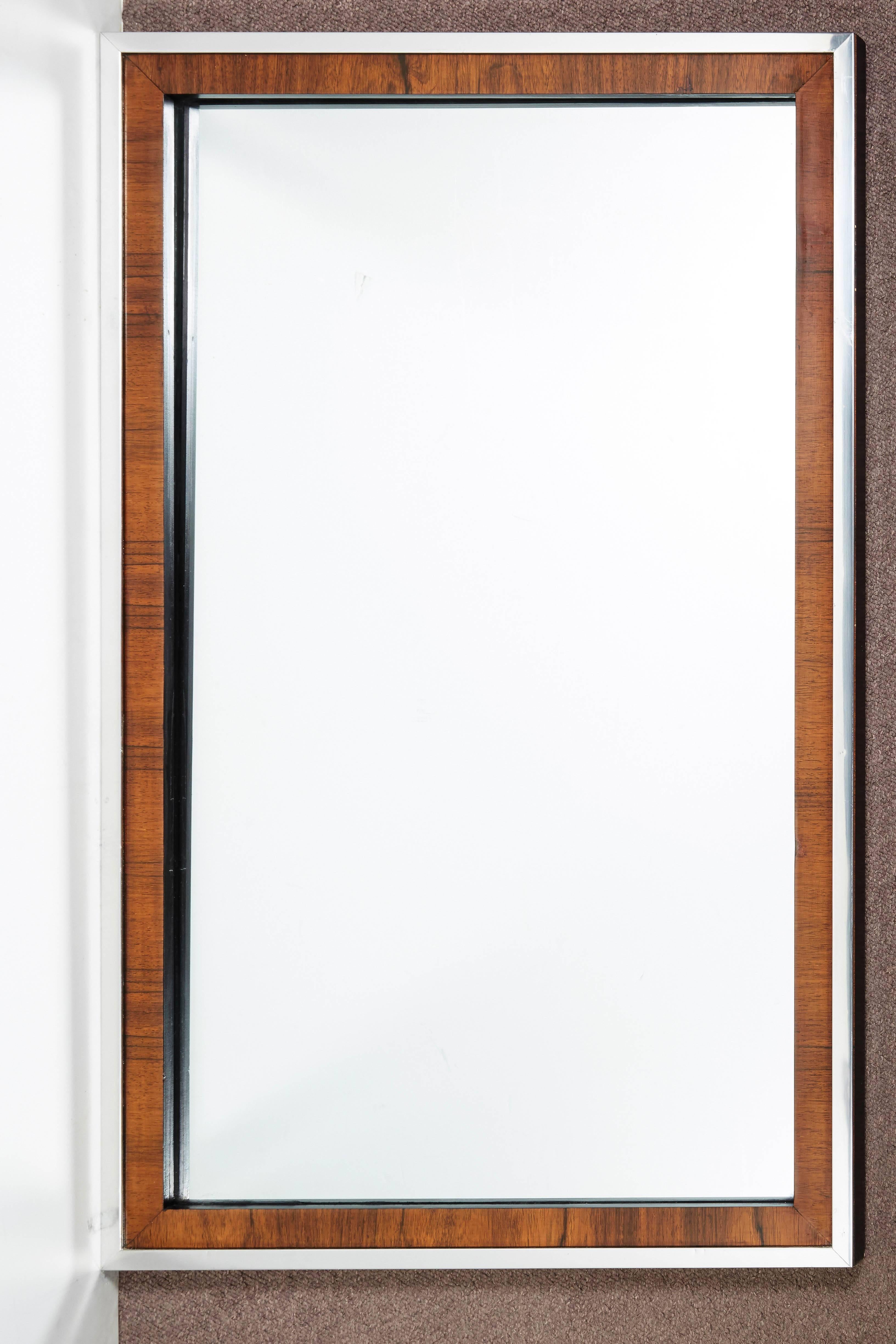 Pair or single available
 A clean, sleek and sophisticated Modernist mirror in rosewood with full chrome surround on all four sides of frame.
Milo Baughman for John Stuart
 Can be hung horizontally or vertically. 
Original glass inset in fine