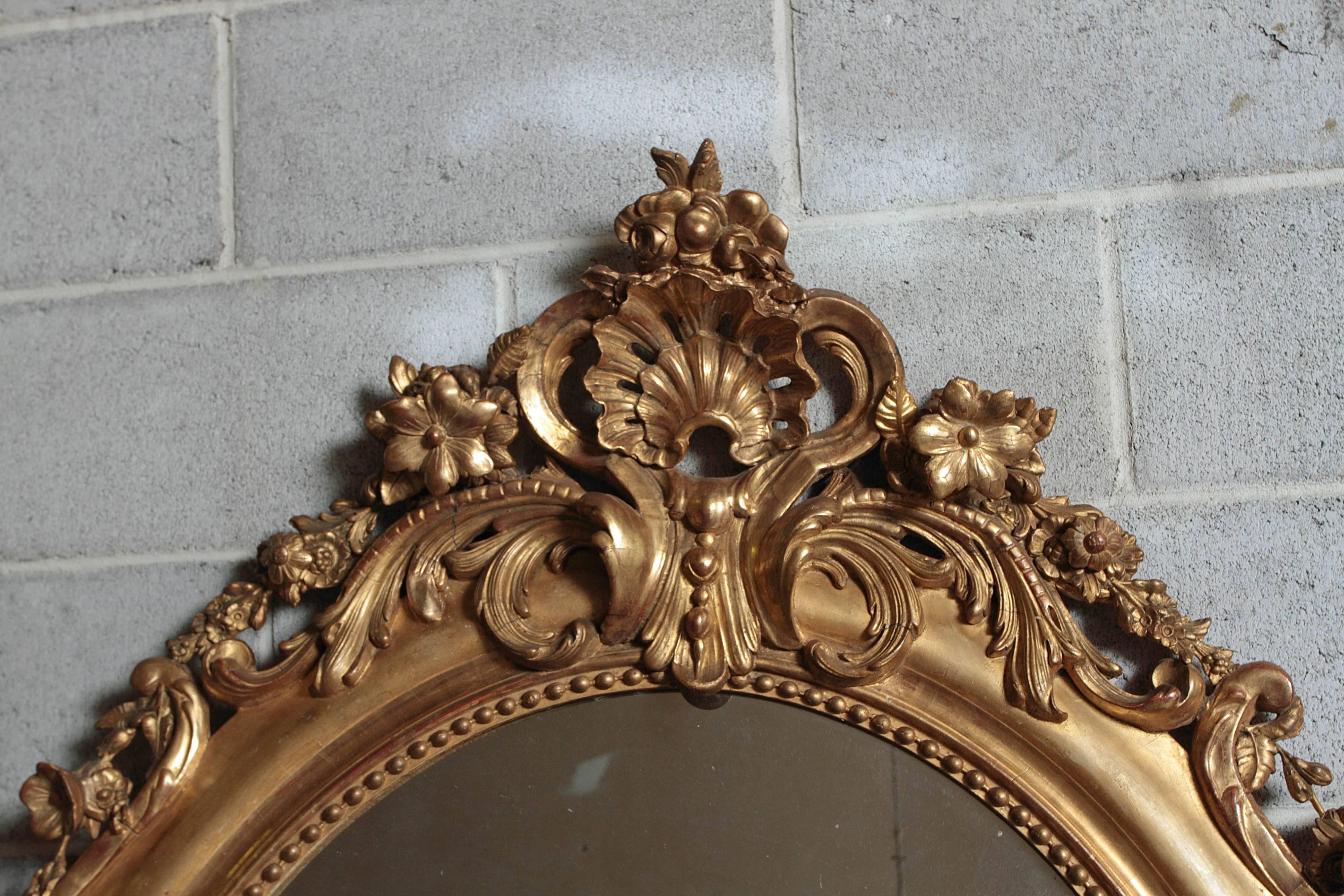 French 19th century finely carved and gilt oval Louis XV mirror.