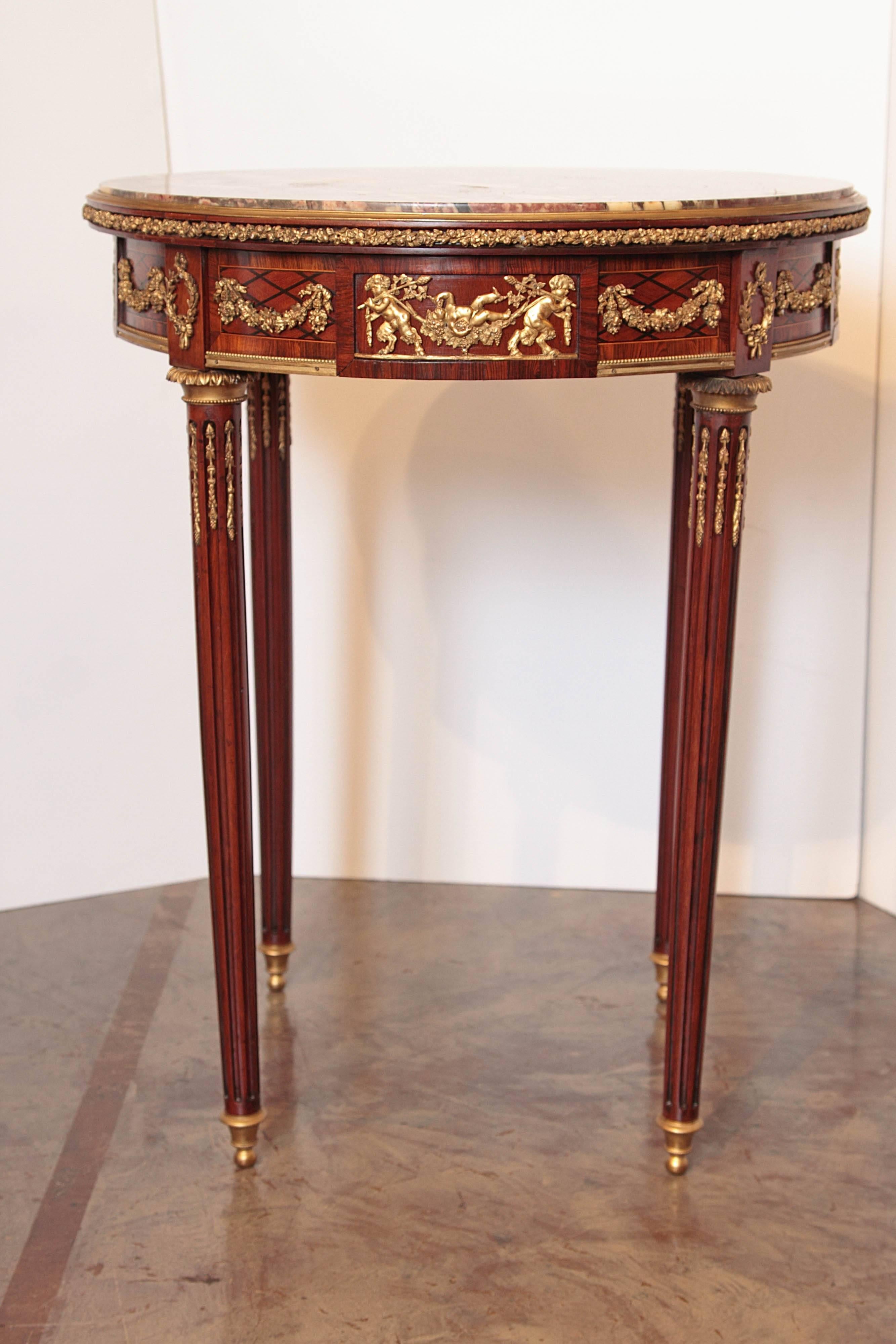 19th century French Louis XVI mahogany and gilt bronze trimmed marble top gueridon table

Fine gilt bronze detail . Original breche violette marble top. Single drawer